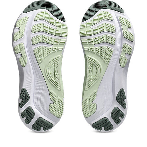 Close-up of a pair of shoes with green and gray sole design on a white background