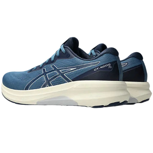 Blue running shoe with white sole on a white background