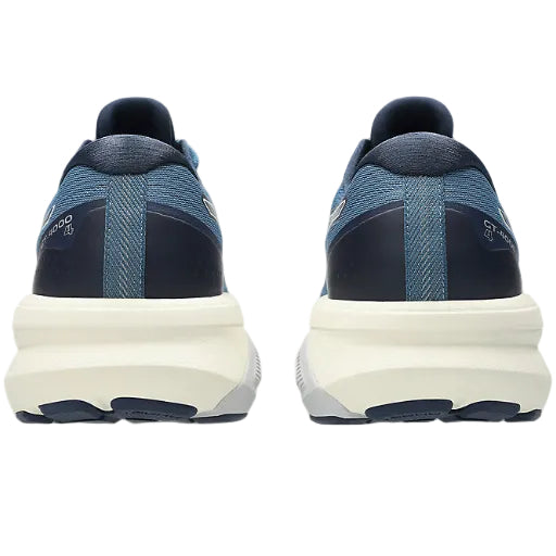 Blue running shoes with white sole on a white background
