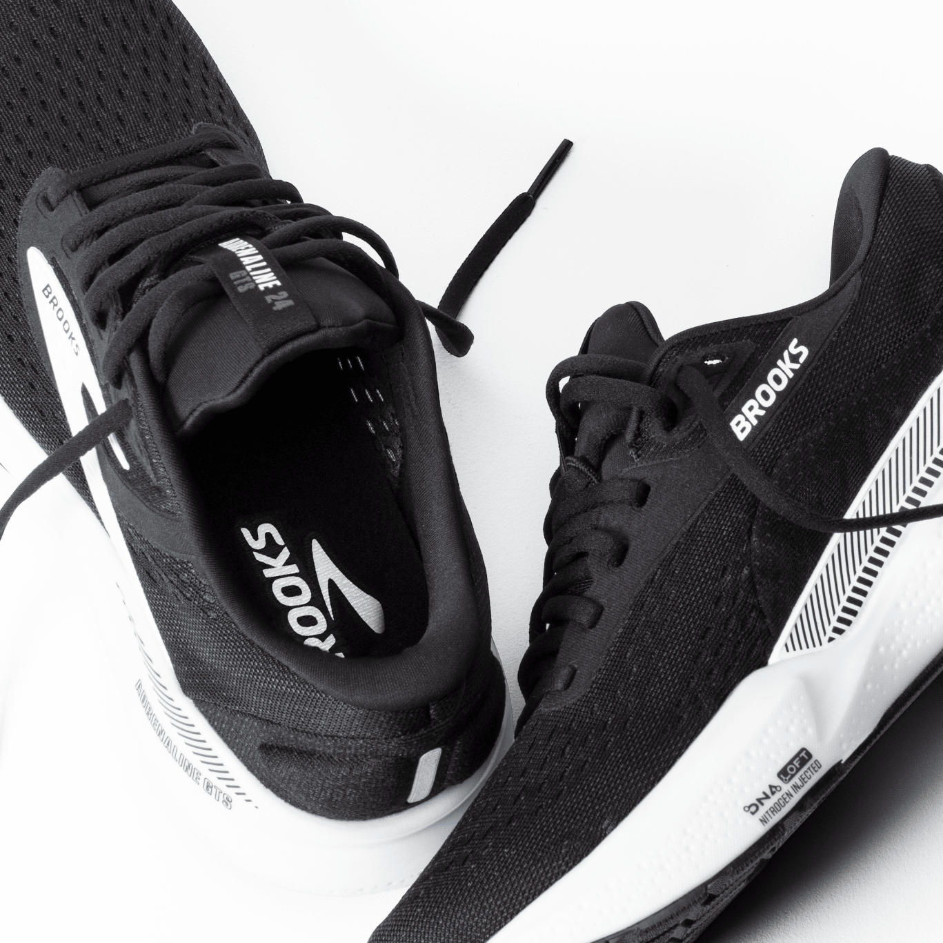 Black running shoes with 'Brooks' branding on a white background
