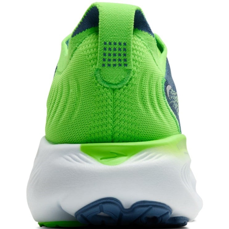 Green and blue athletic shoe with white sole on a white background