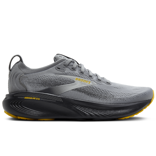 Gray running shoe with black sole on a white background