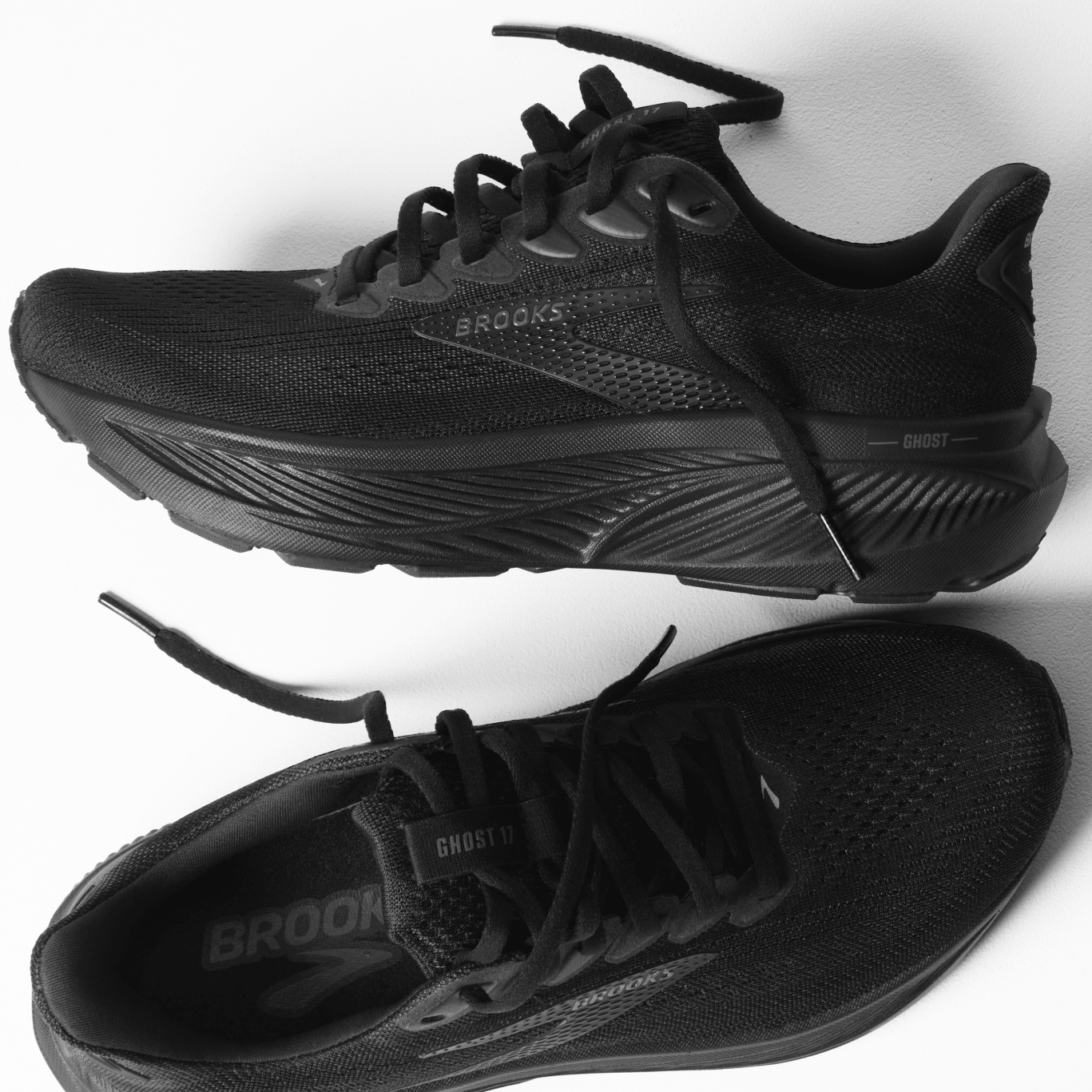 Black running shoes with 'Brooks' branding on a white background