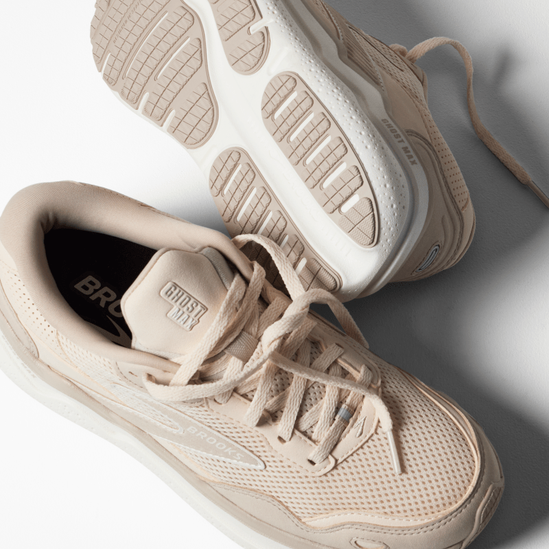 Beige sneakers with white soles on a light gray background