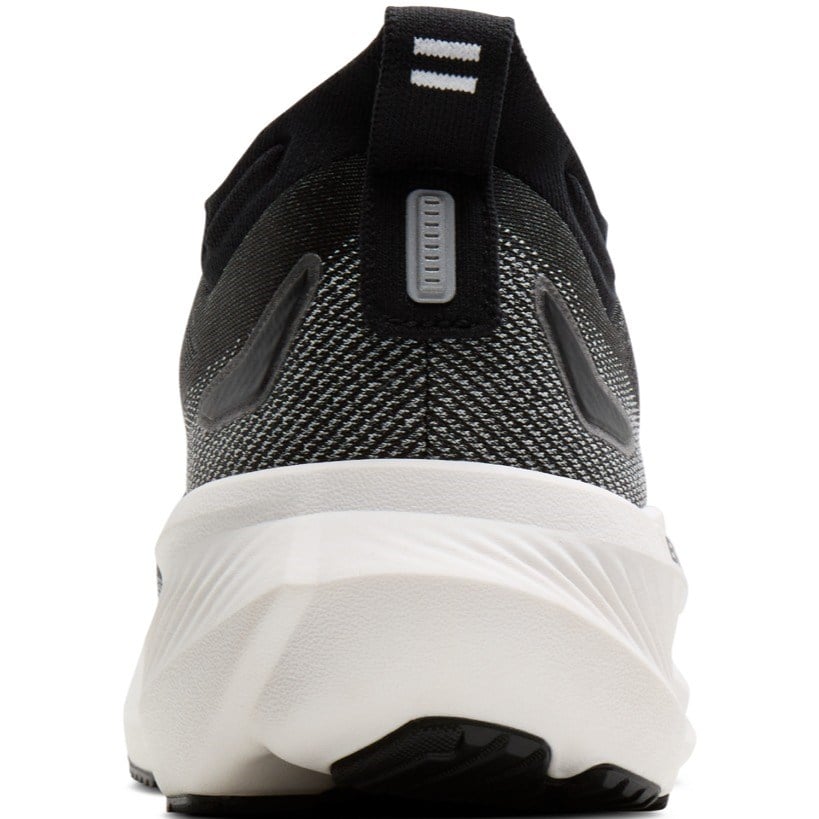 Close-up rear view of a black and gray knit athletic shoe with a thick white midsole and a small gray pull tab on the heel.