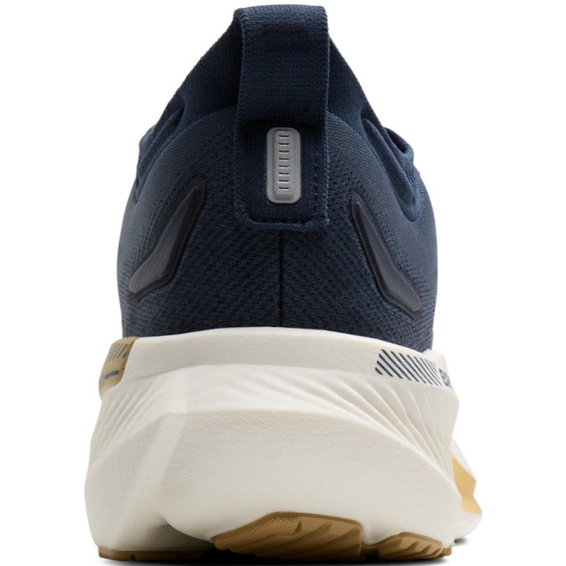 Navy running shoe with white sole on a white background