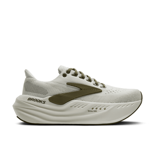 White running shoe with green accents on a transparent background
