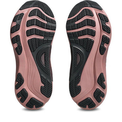 Close-up of pink and black shoe soles on a white background