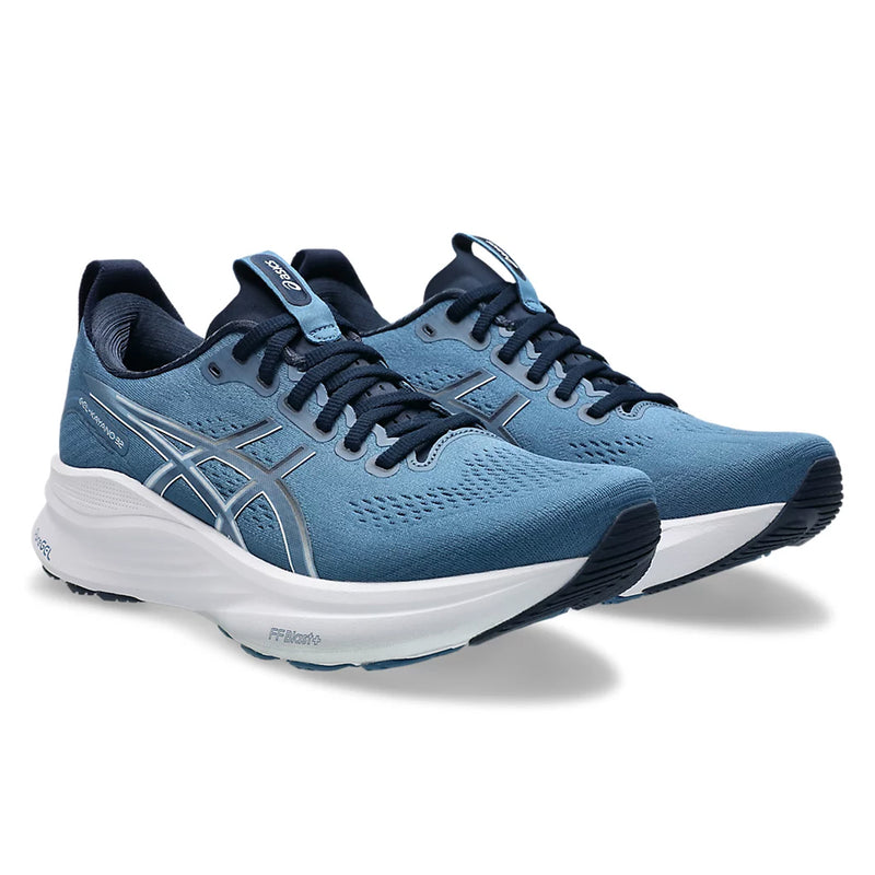 Blue running shoes with white soles on a white background