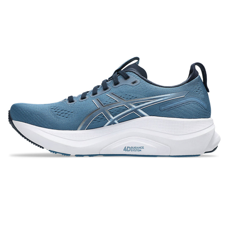 Blue running shoe with white sole on a white background