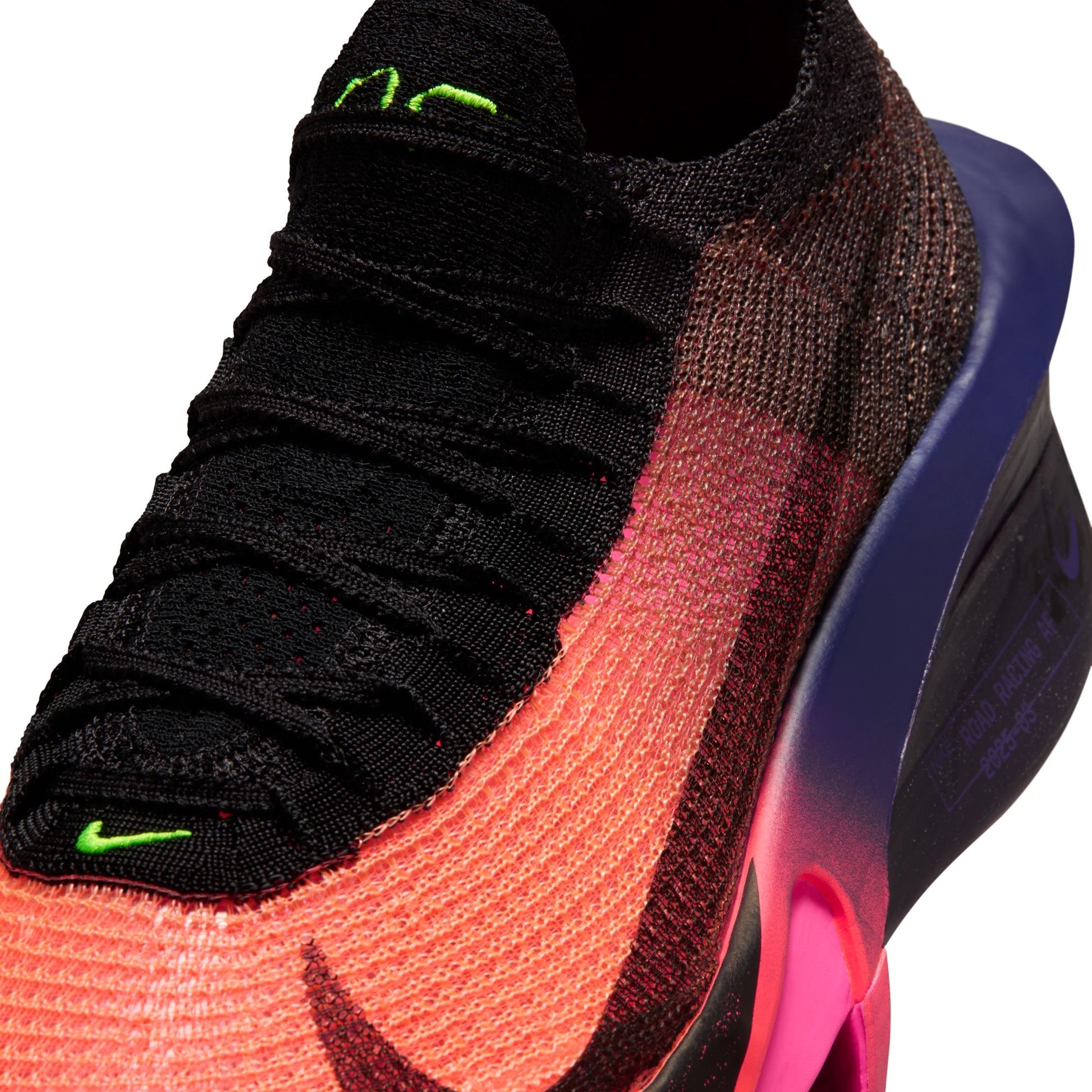 Close-up of a colorful sneaker with black, red, and pink design on a white background