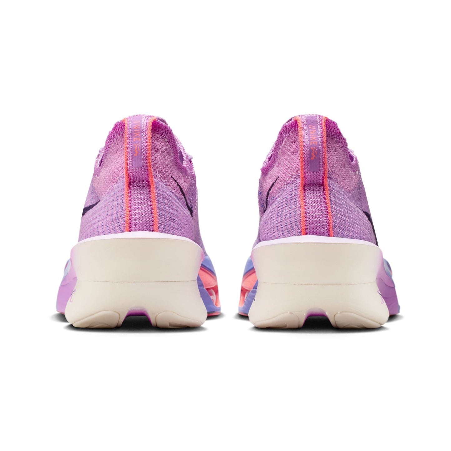 Purple running shoes with a white sole on a white background