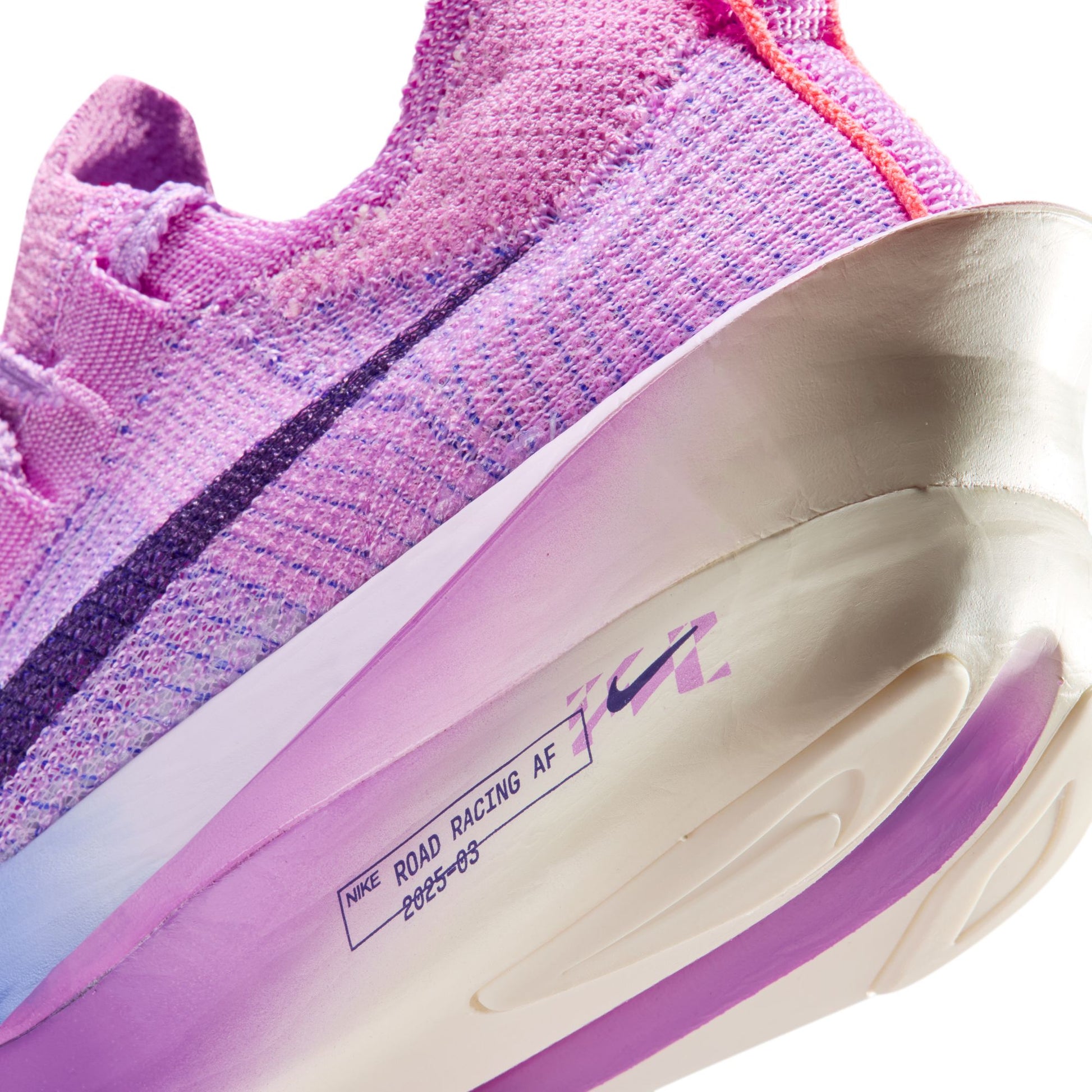 Close-up of a pink and purple athletic shoe with a visible Nike logo.