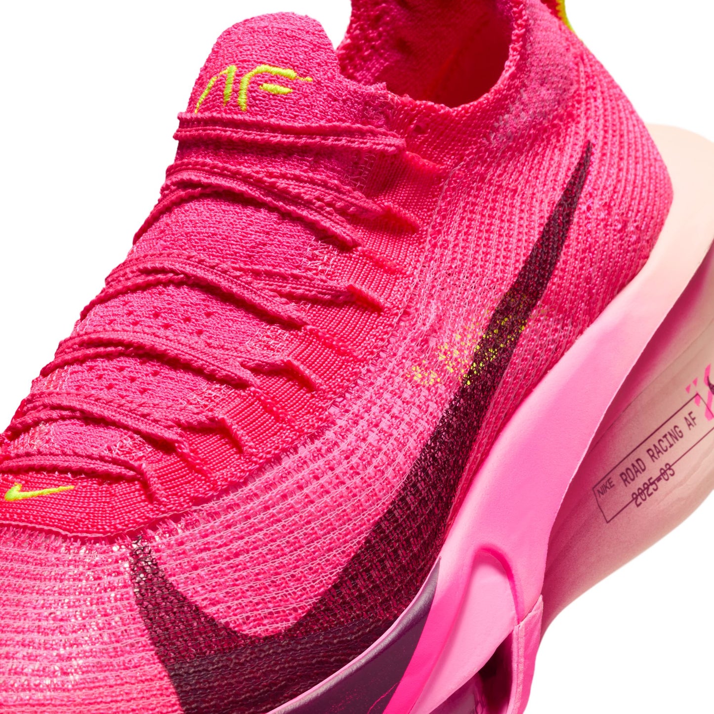 Close-up of a pink athletic shoe with black swoosh logo on a white background