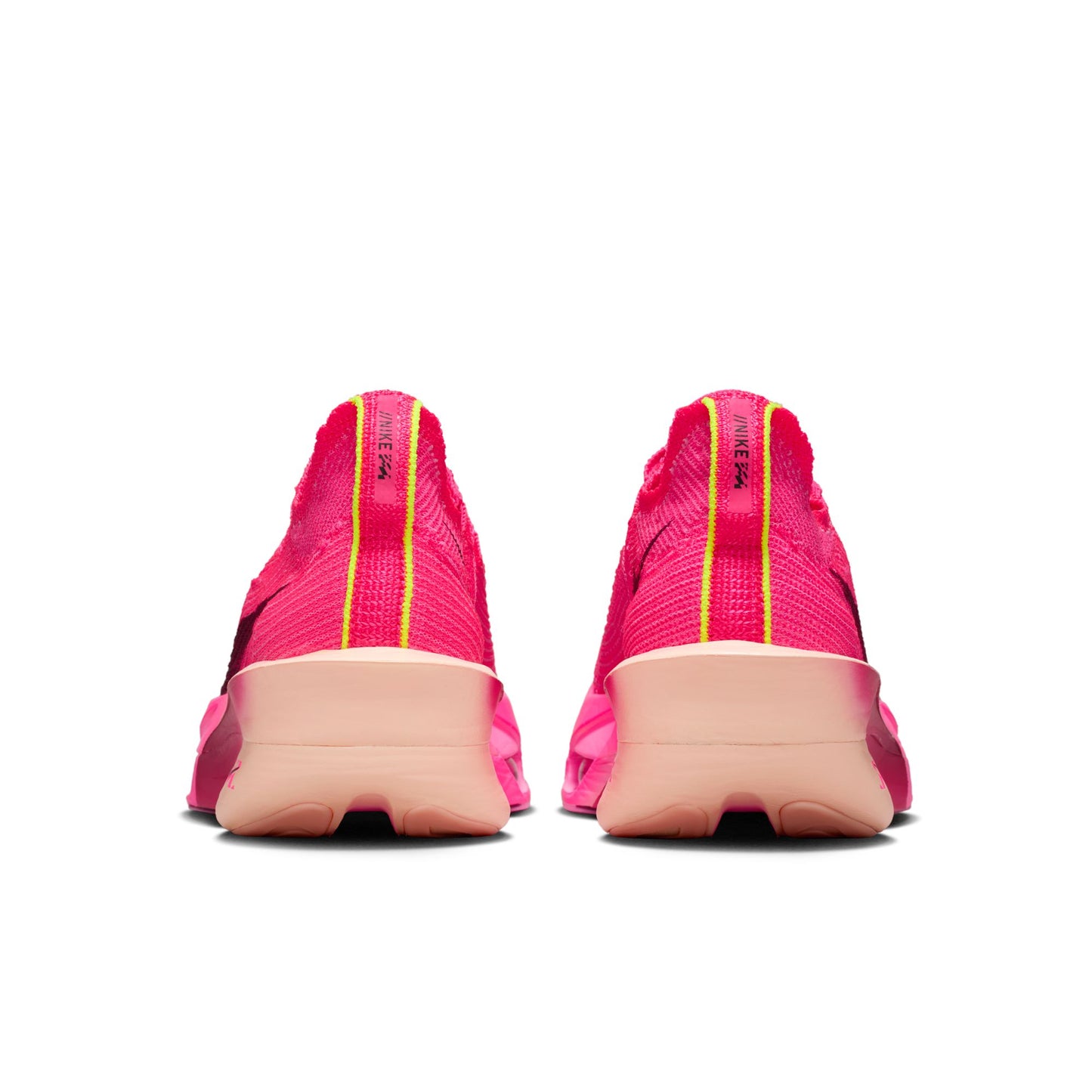 Pink athletic shoes with yellow accents on a white background