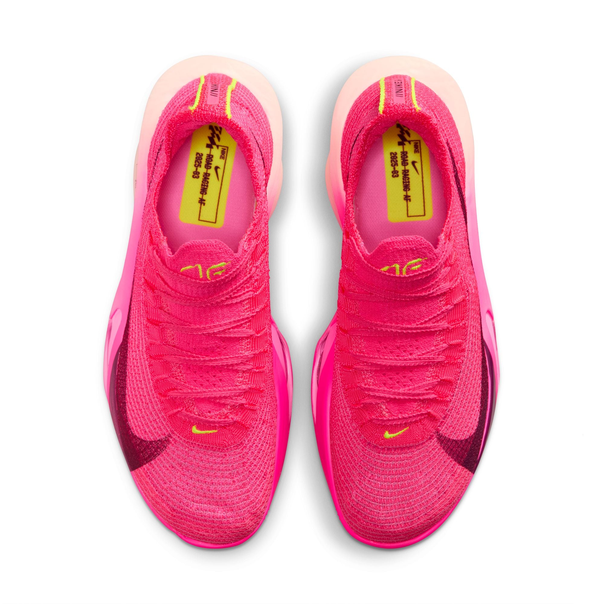 Pink running shoes with yellow accents on a white background