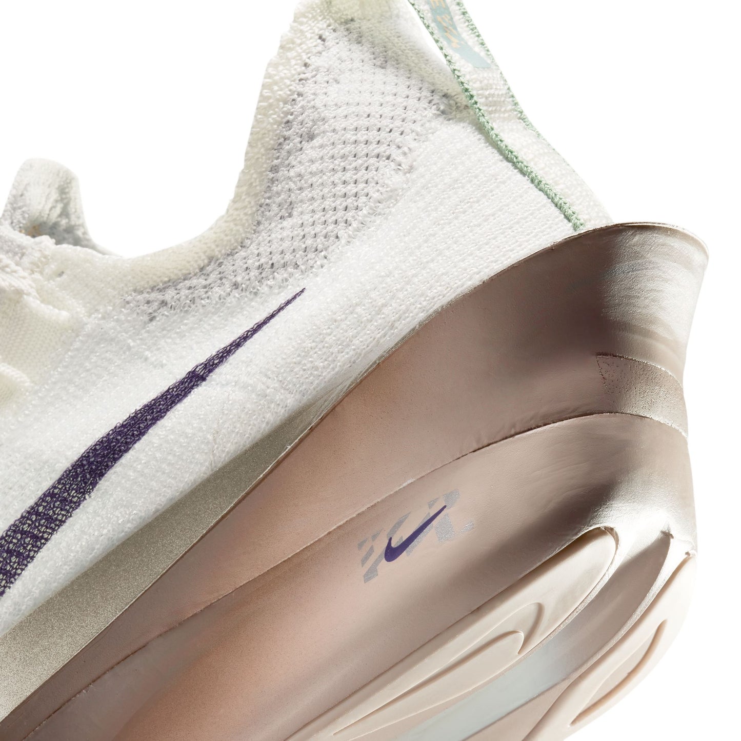 Close-up of a white sneaker with a purple swoosh logo on a white heel close up background