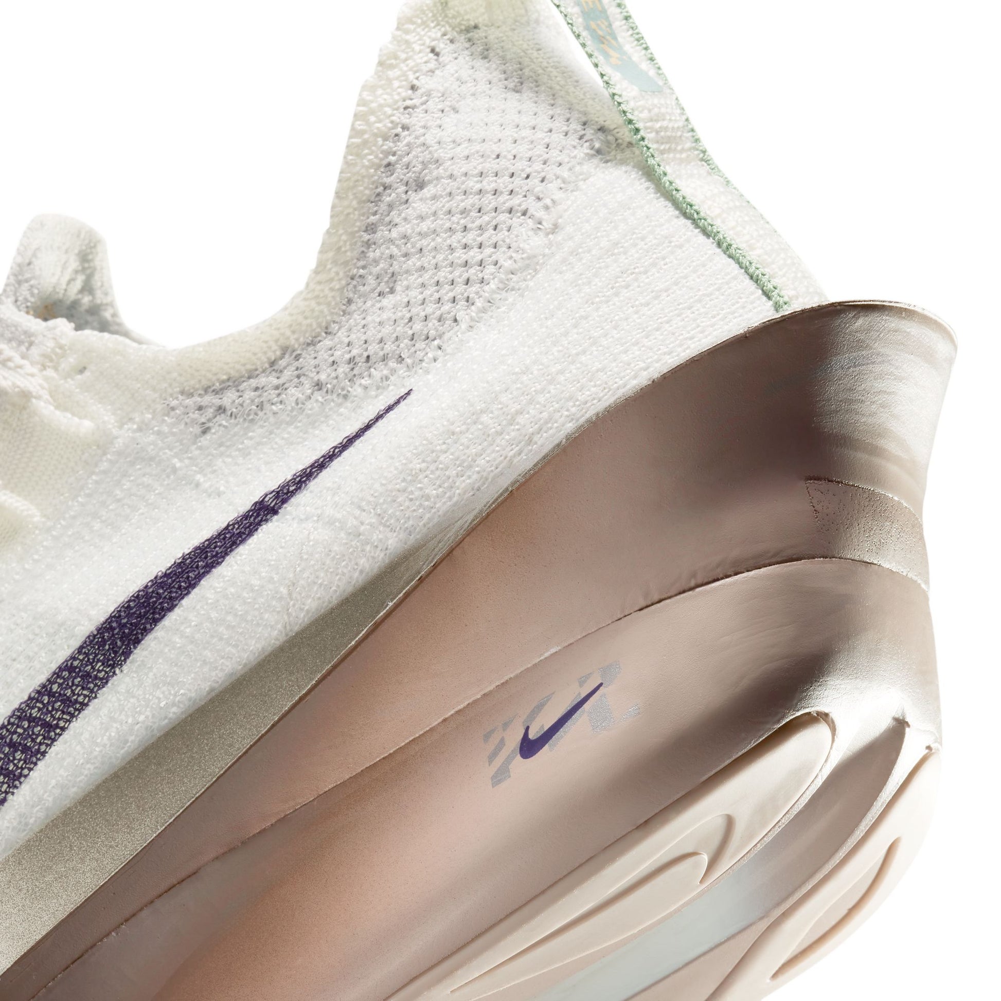 Close-up of a white sneaker with a purple swoosh logo on a white heel close up background