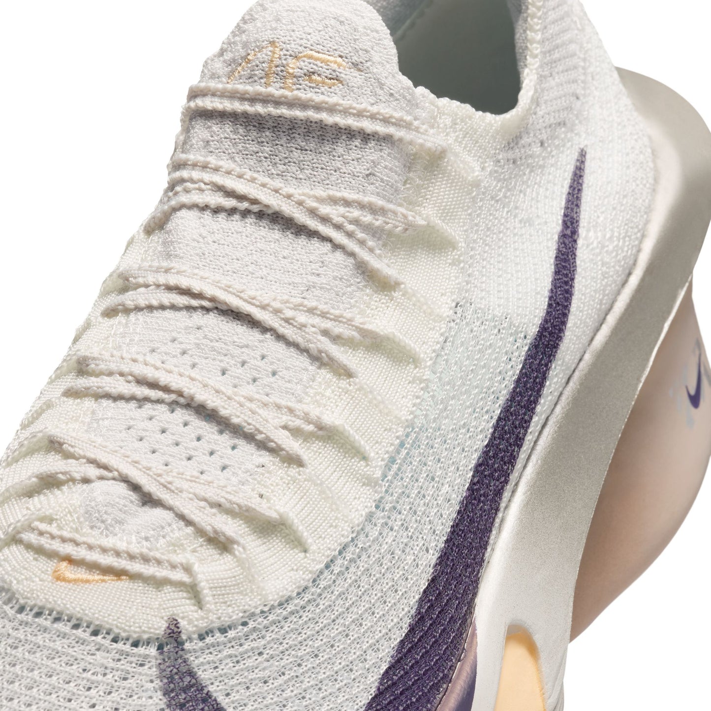 Close-up of a white running shoe with purple accents on a light gray background laces