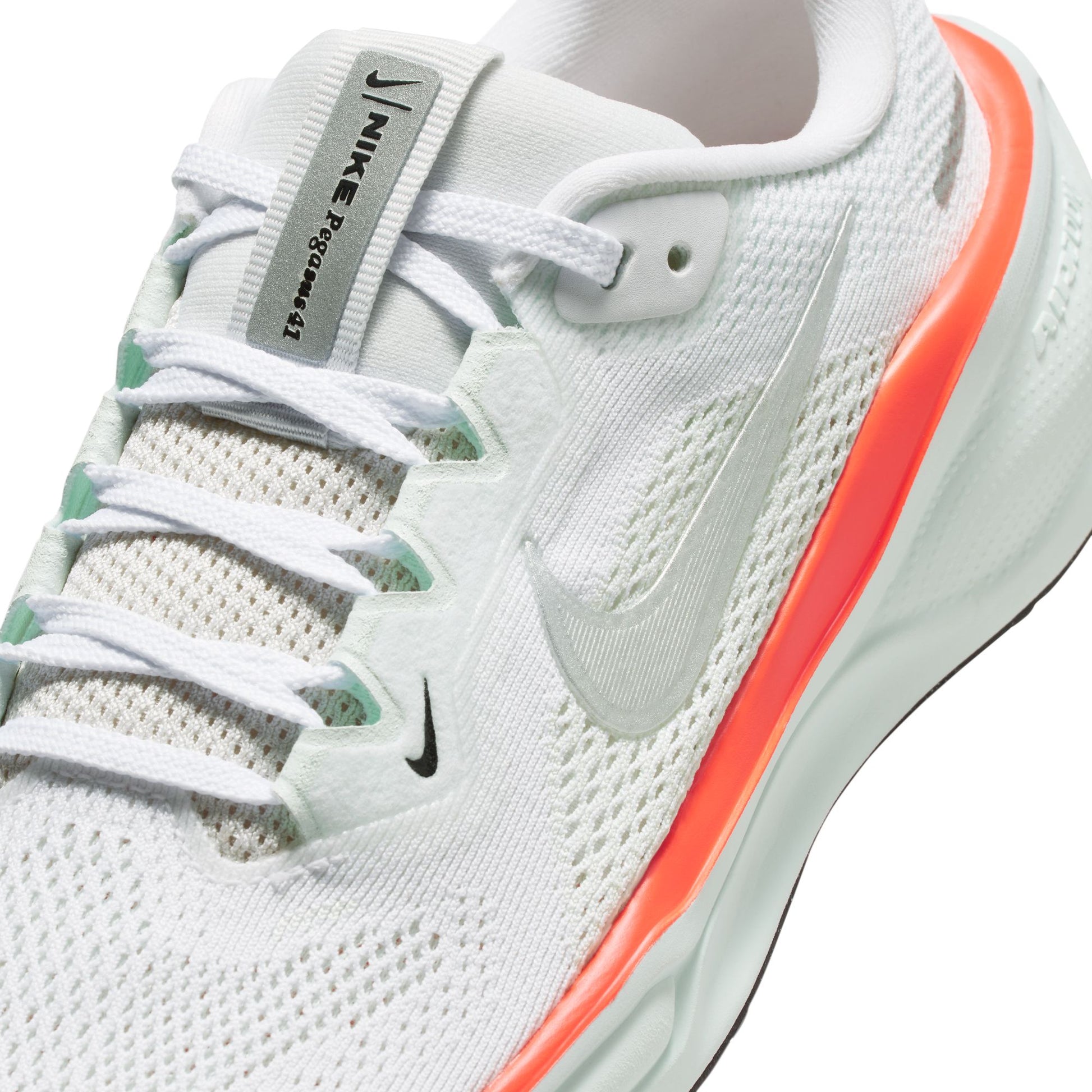 White running shoe with orange accent and Nike logo on a white background