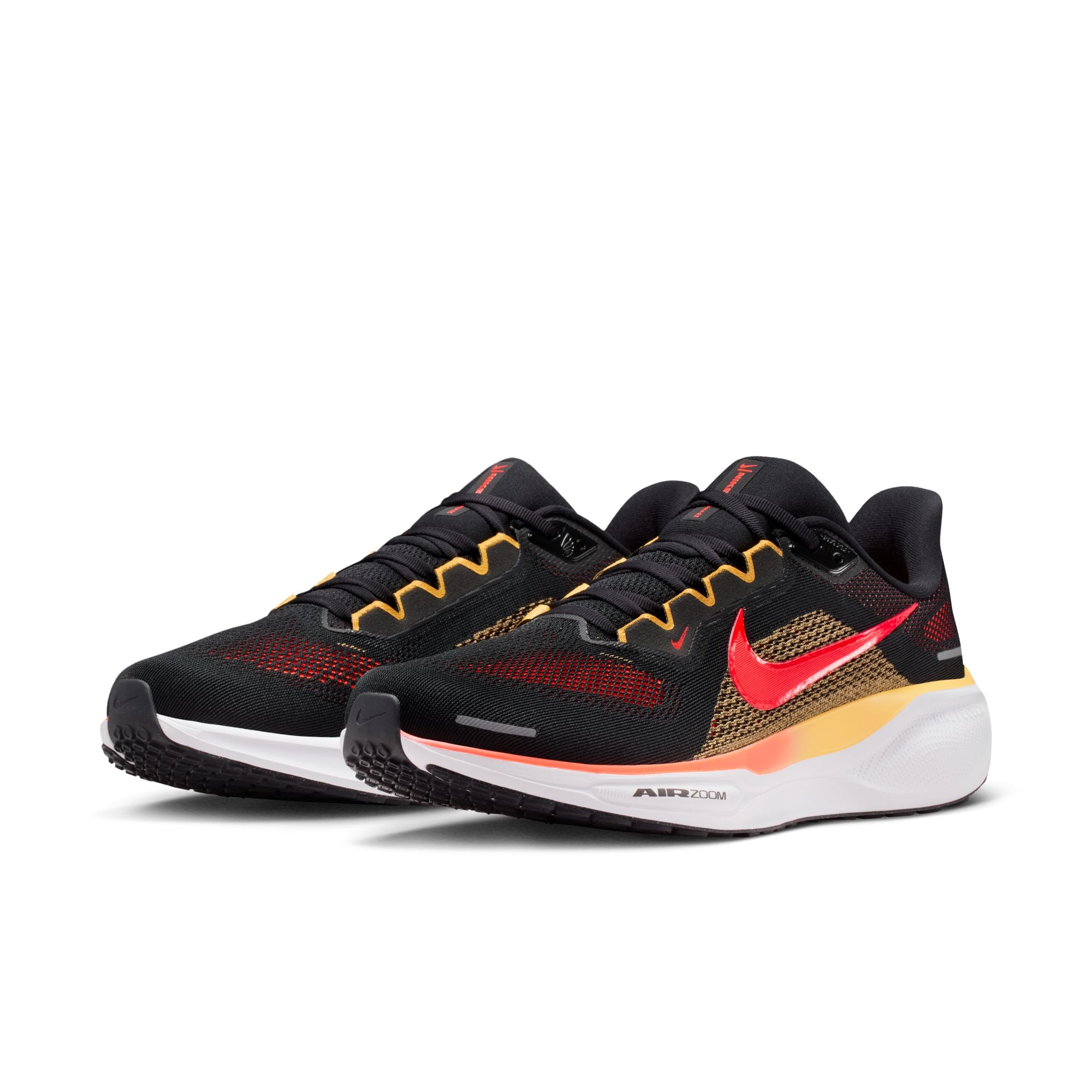Black running shoes with red and yellow accents on a white background