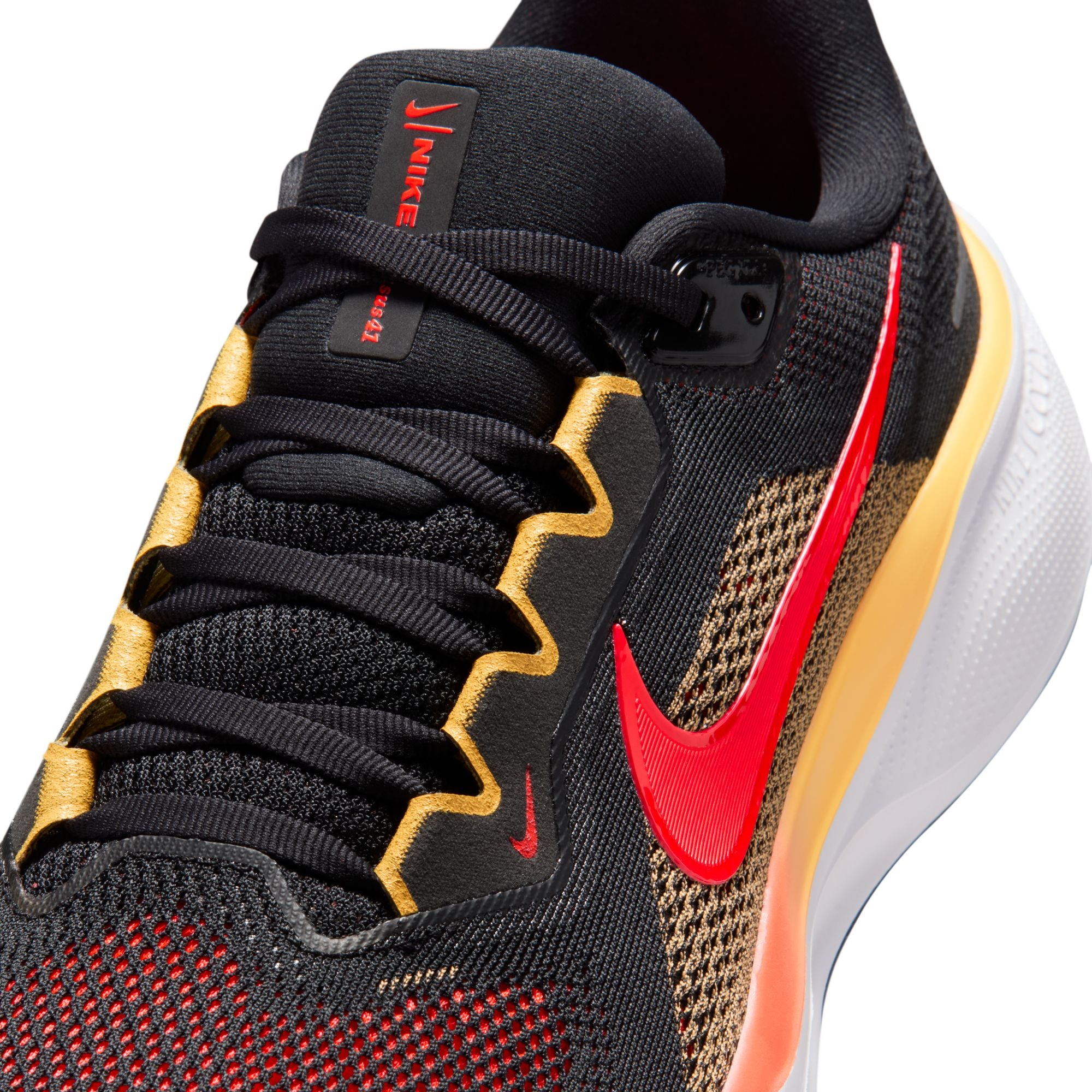 Black Nike running shoe with red and yellow accents on a white background