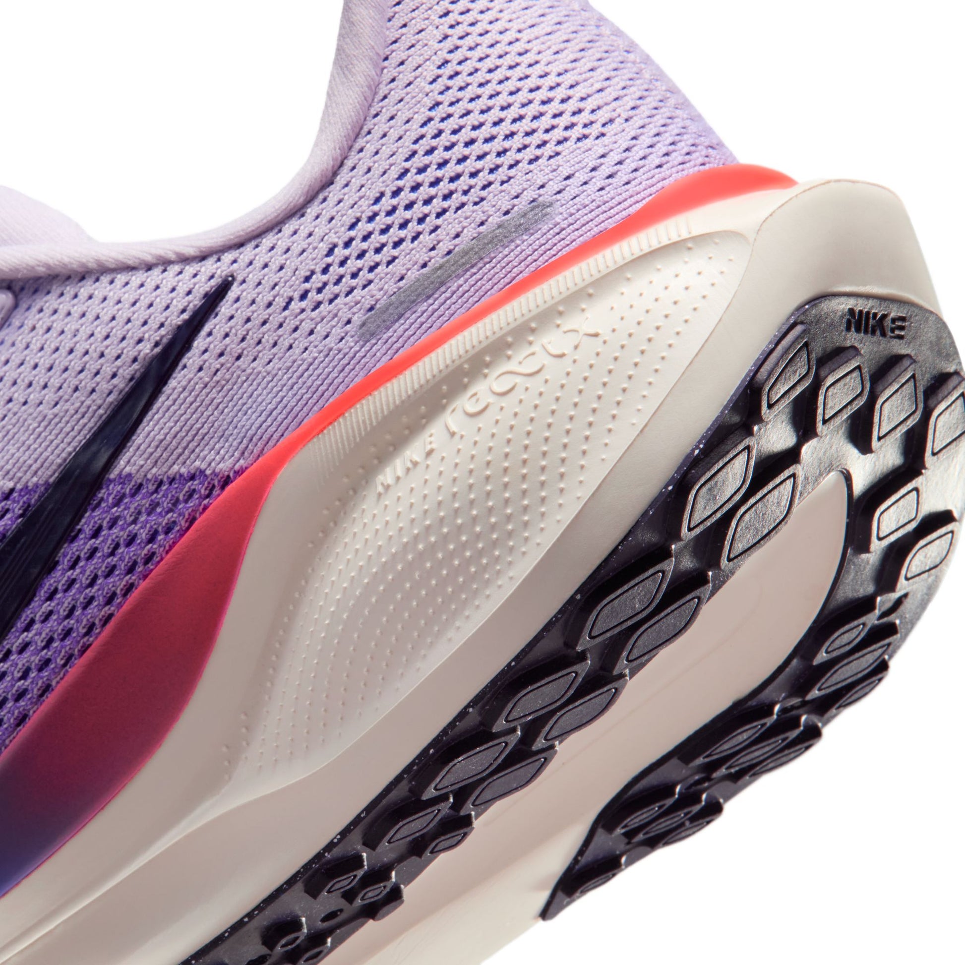 Close-up of a purple running shoe with a white sole and Nike logo.