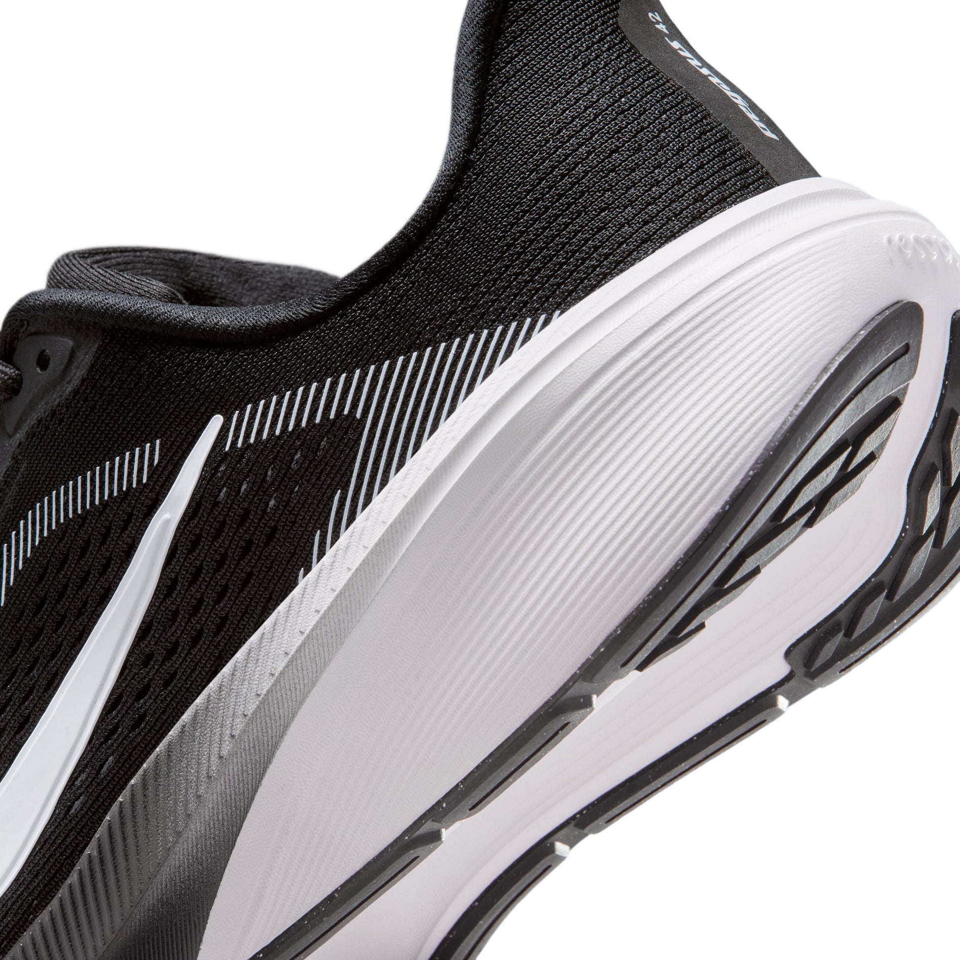 Black and white running shoe with visible brand logo on a white background
