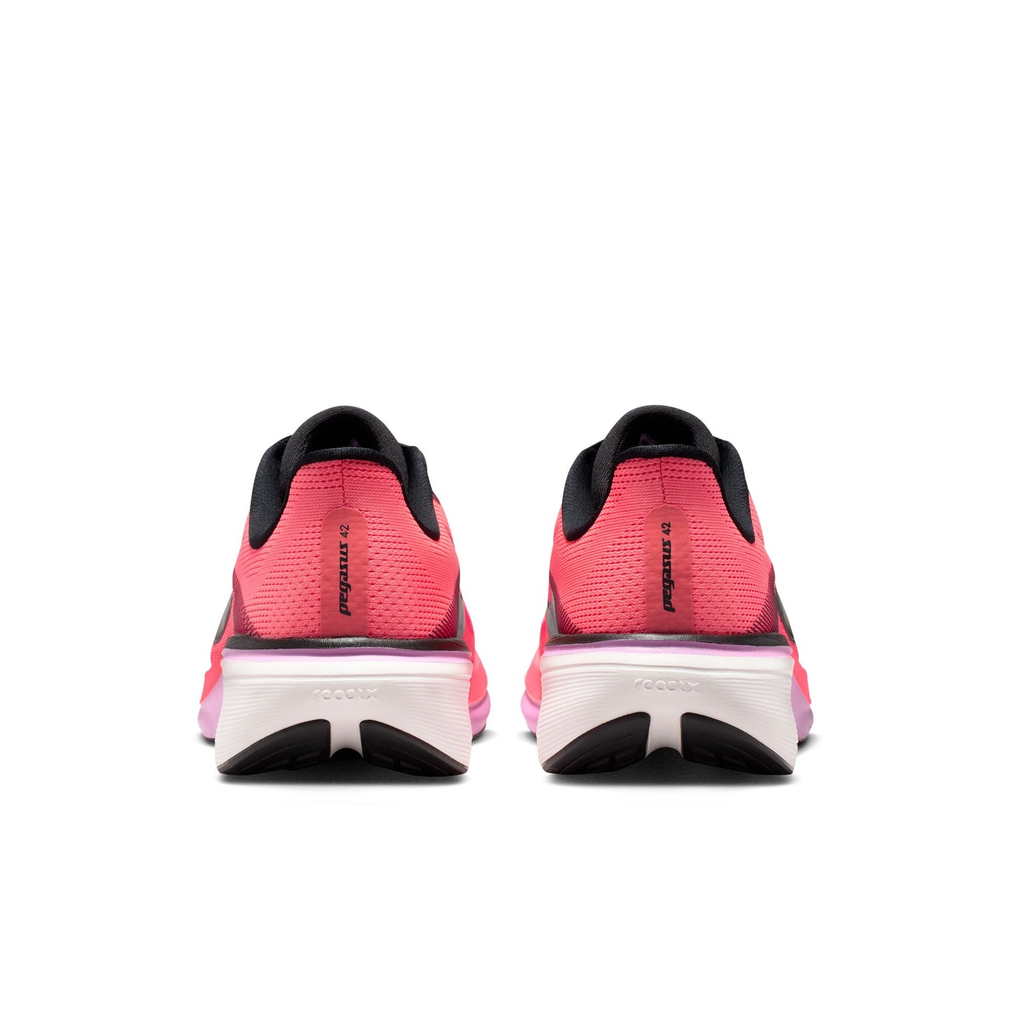 Pink running shoes with black soles on a white background