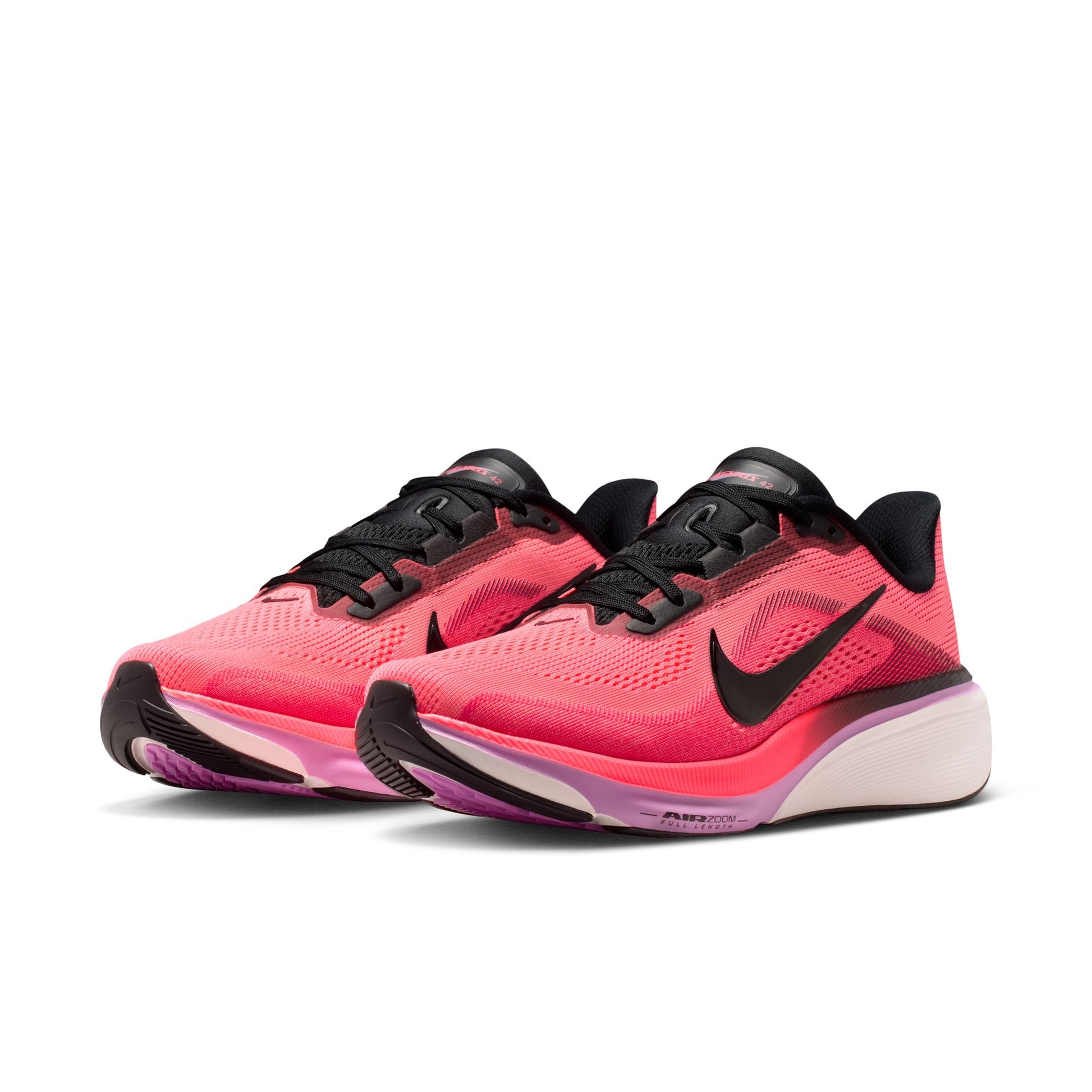 Pink and black running shoes with Nike logo on a white background