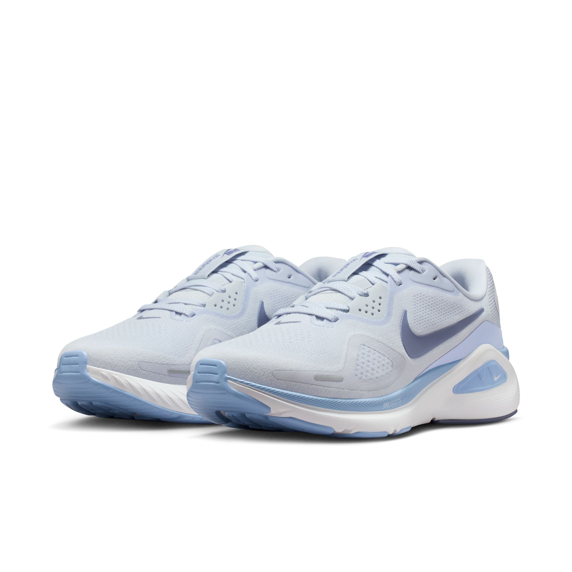 Pair of light blue athletic shoes with a Nike logo on a white background