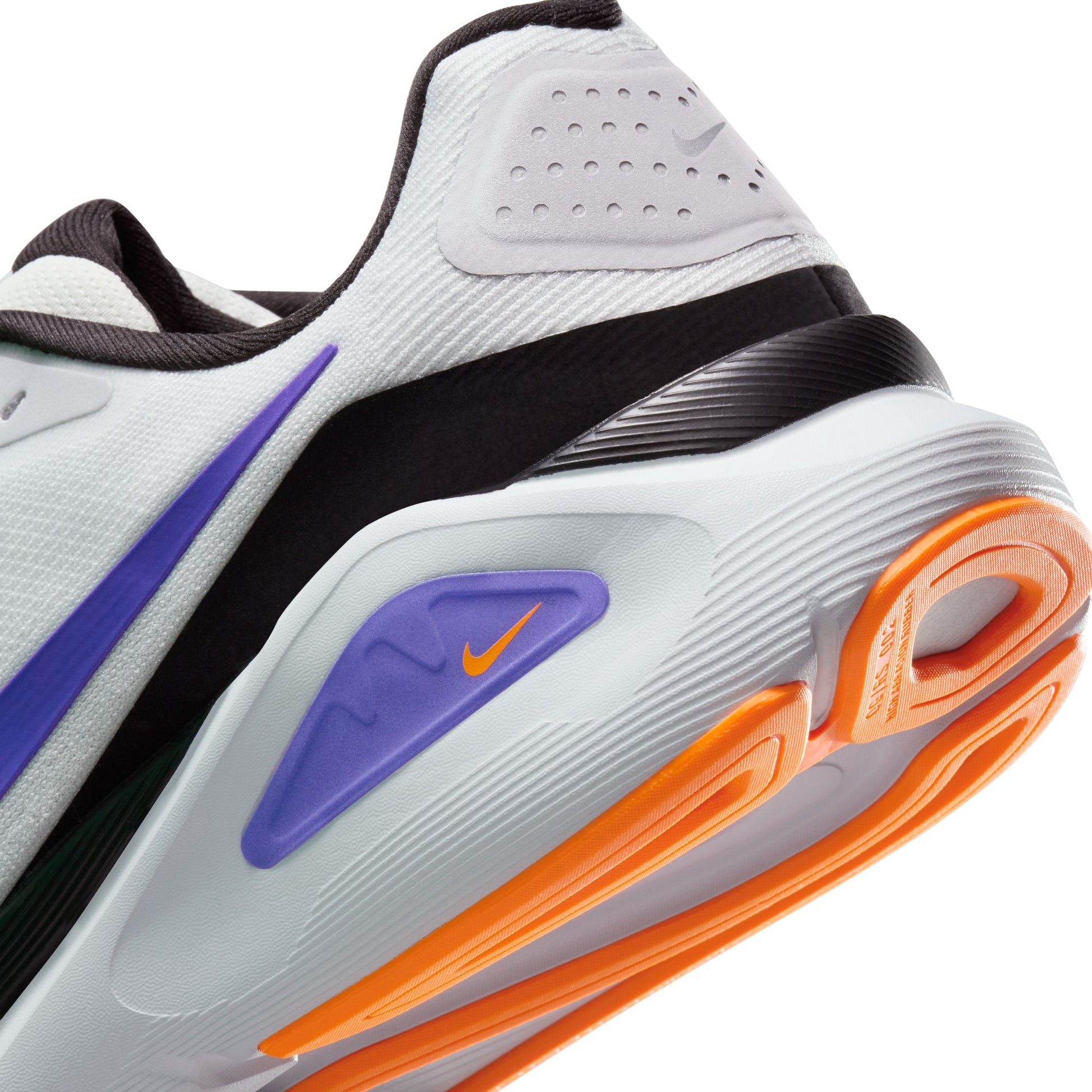 Close-up of a Nike sneaker with white, orange, and purple accents on a white background