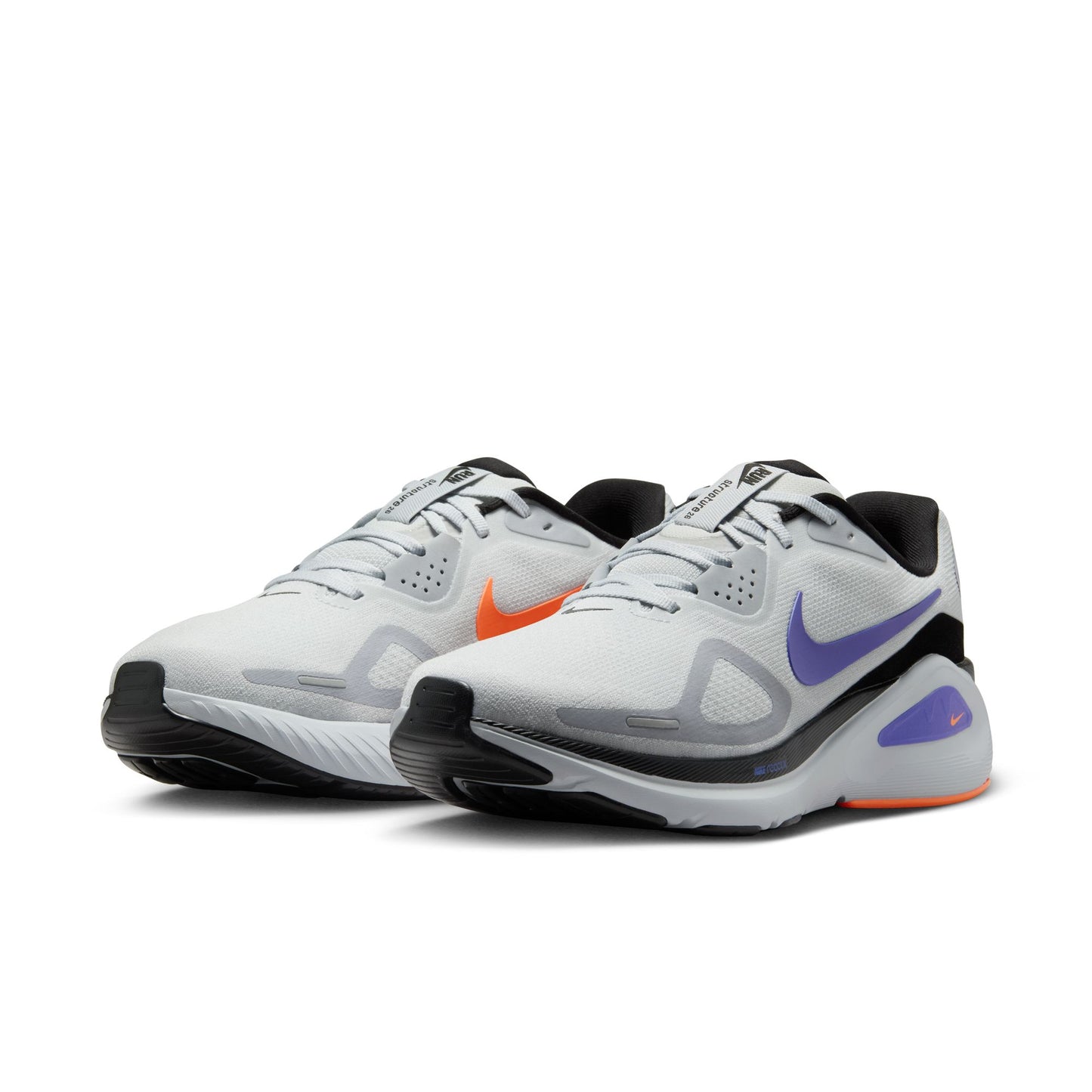 Pair of white athletic shoes with black and purple accents on a white background