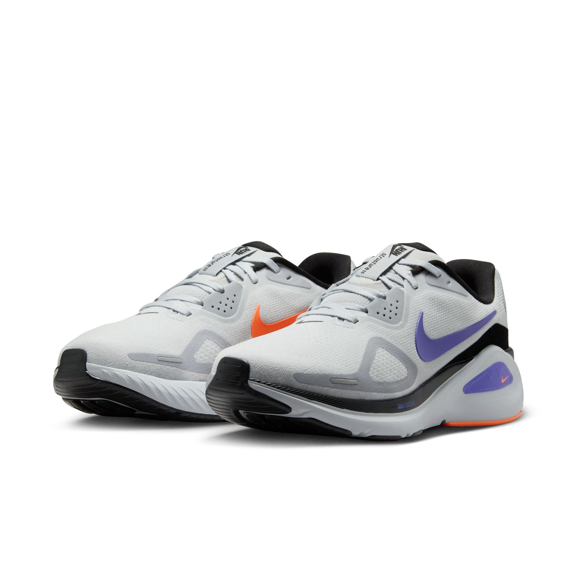 Pair of white athletic shoes with black and purple accents on a white background
