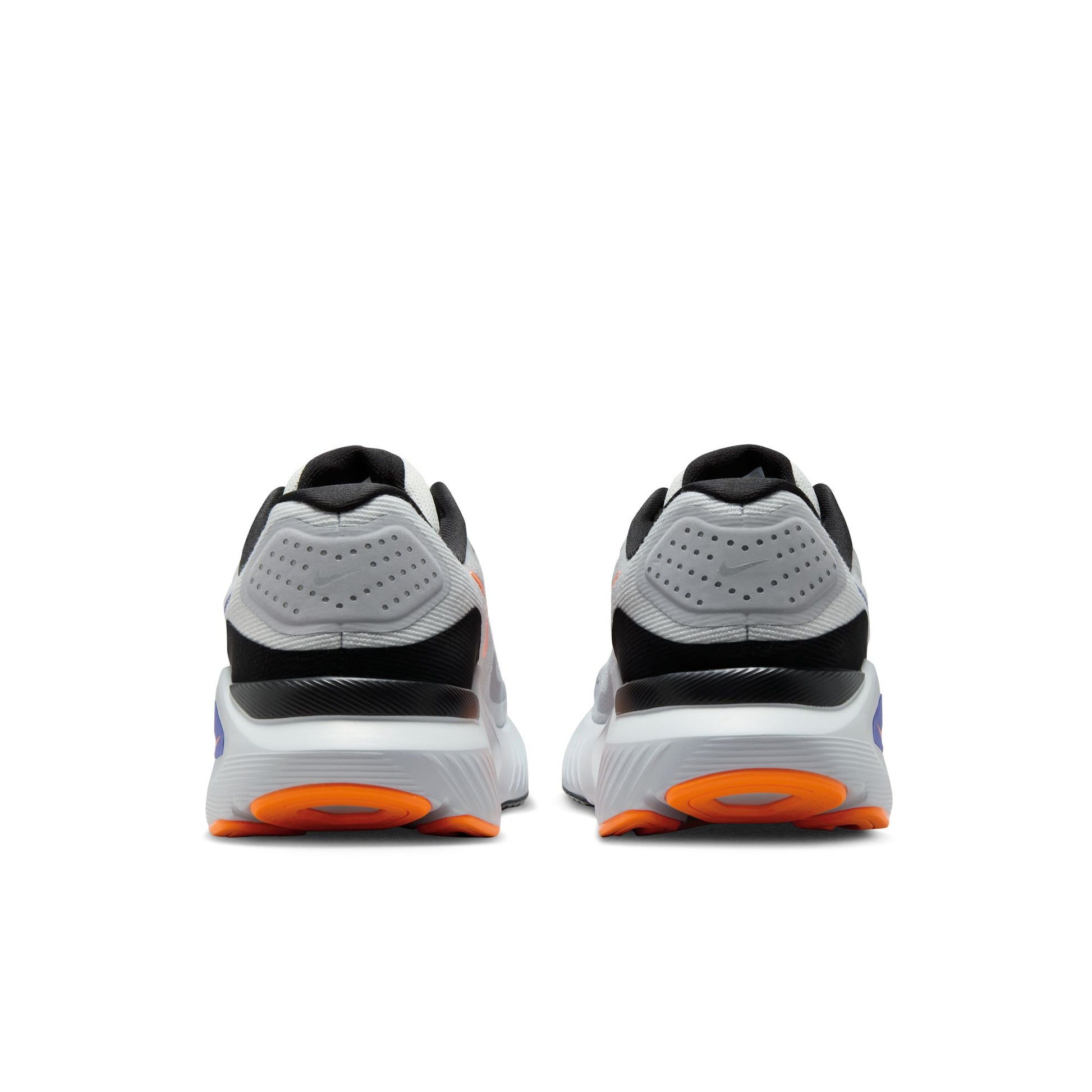 Pair of white running shoes with black and orange accents on a white background