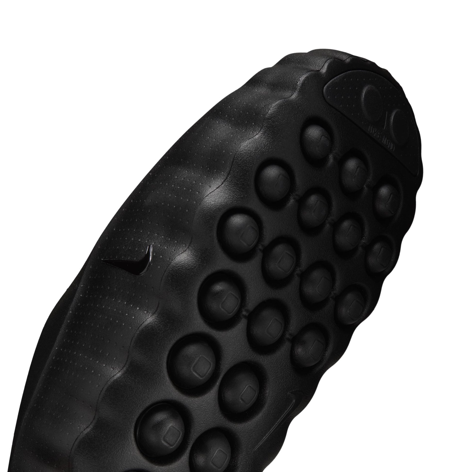 Close-up of a black textured shoe sole on a white background
