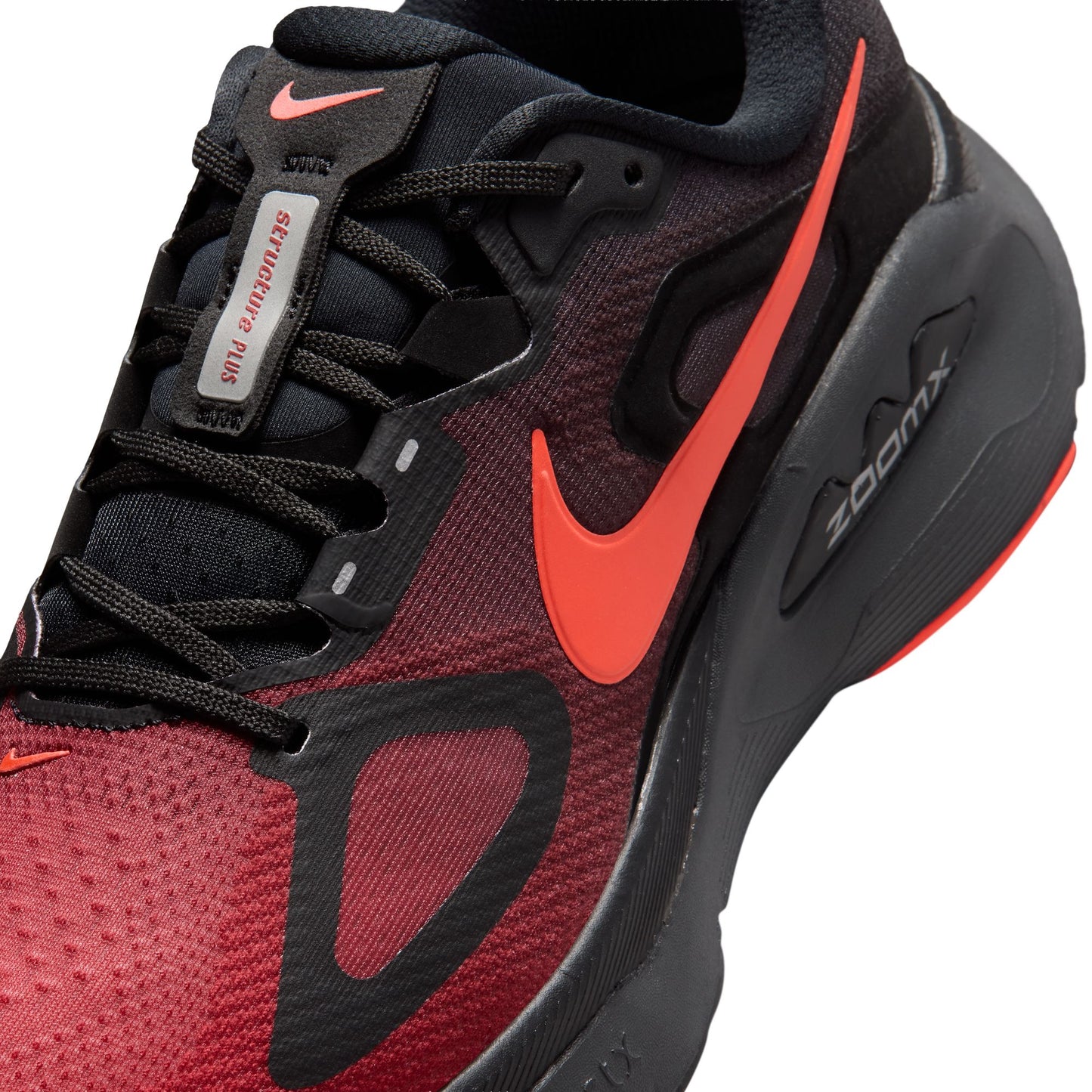 Red and black sneaker with orange Nike logo on a white background