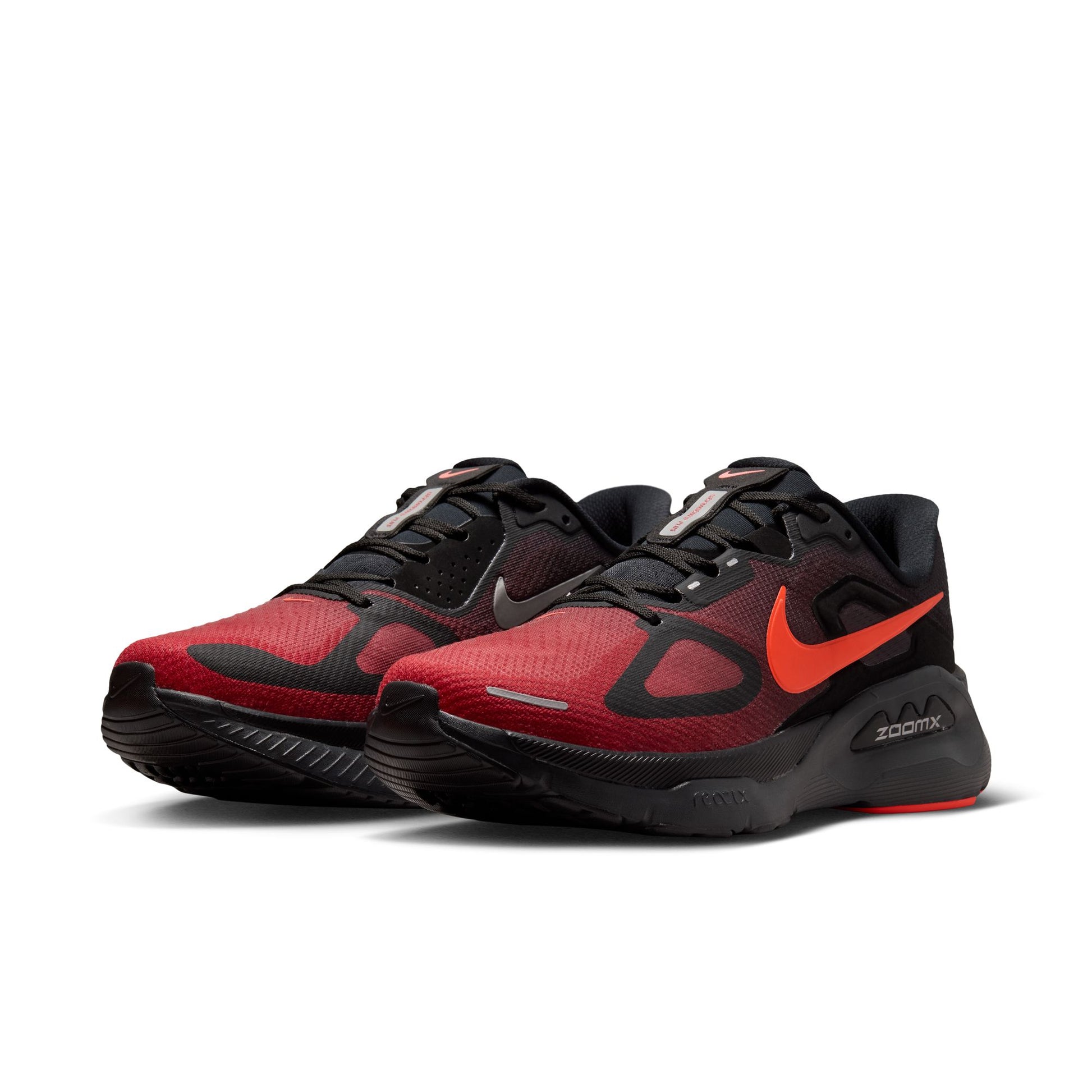 Red and black running shoes with Nike logo on a white background