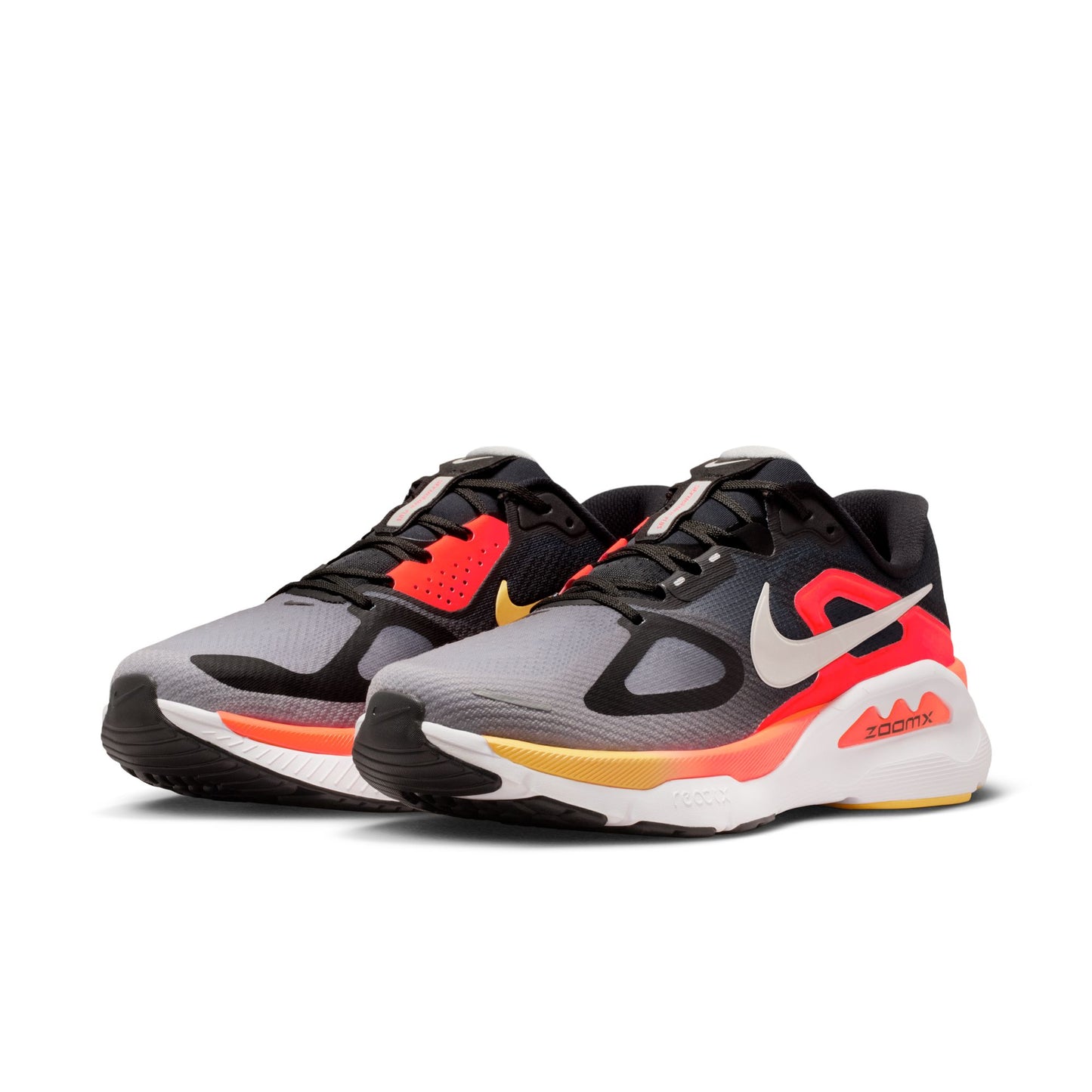 Pair of black, gray, and red athletic shoes on a white background