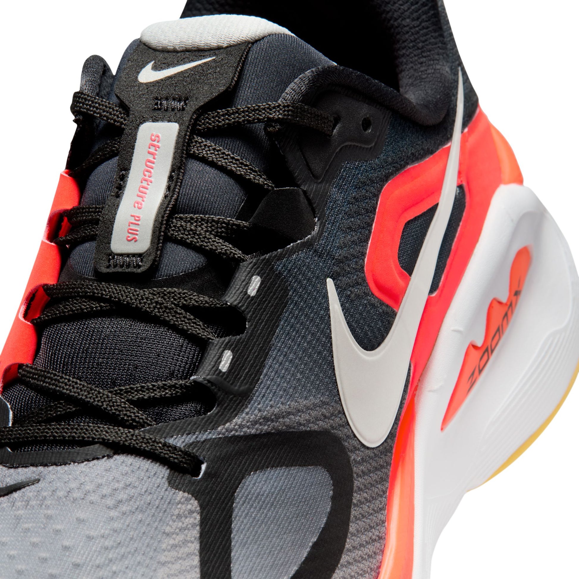 Gray and black sneaker with red accents on a white background
