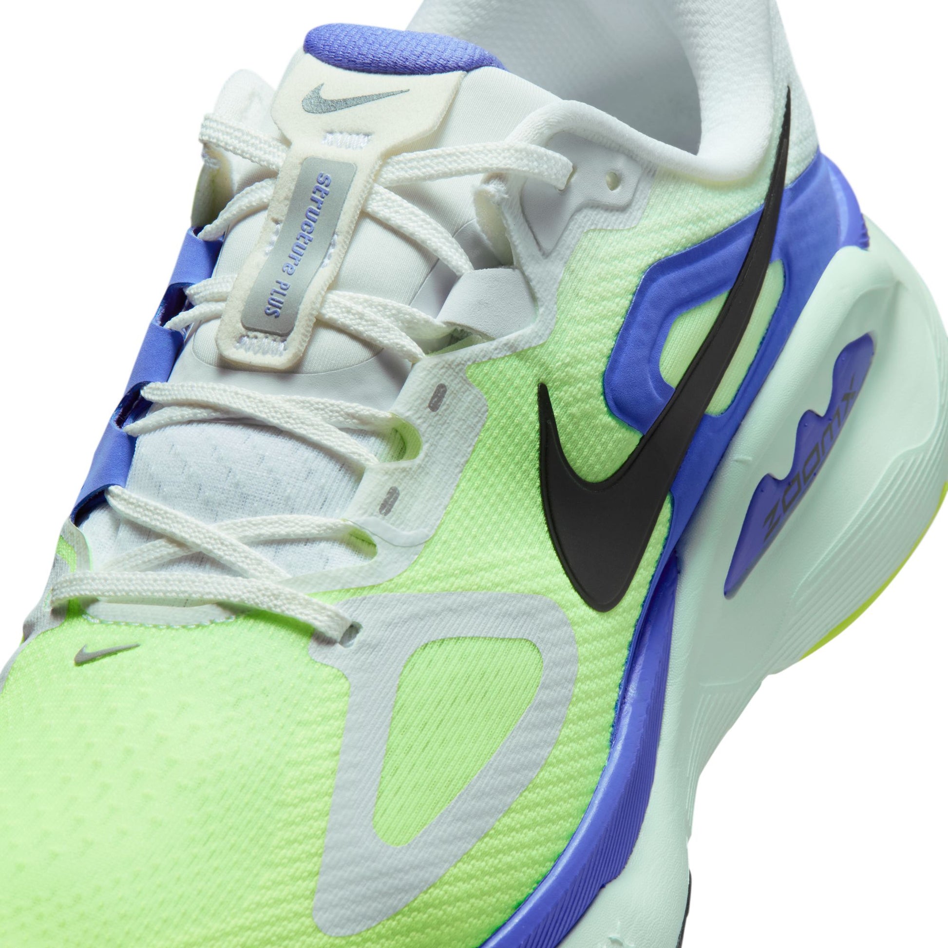 Nike sneaker with green, blue, and white design on a white background