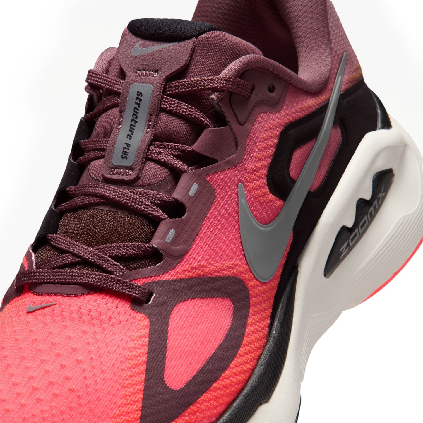 Red and maroon sneaker with Nike logo on a white background
