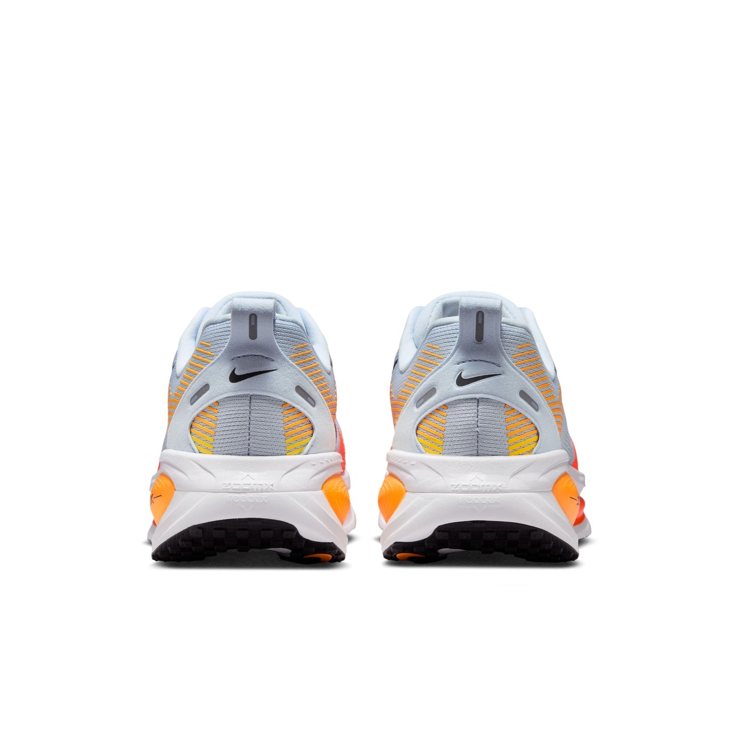Pair of Nike sneakers with orange and black accents on a white background