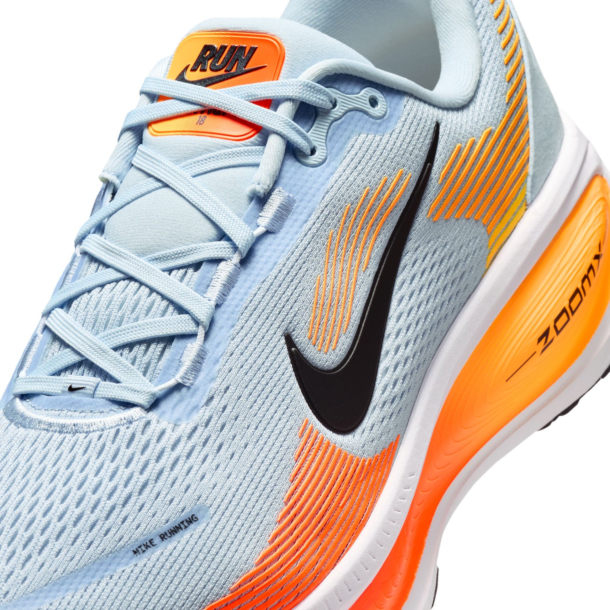 Light blue and orange running shoe with Nike logo on a white background