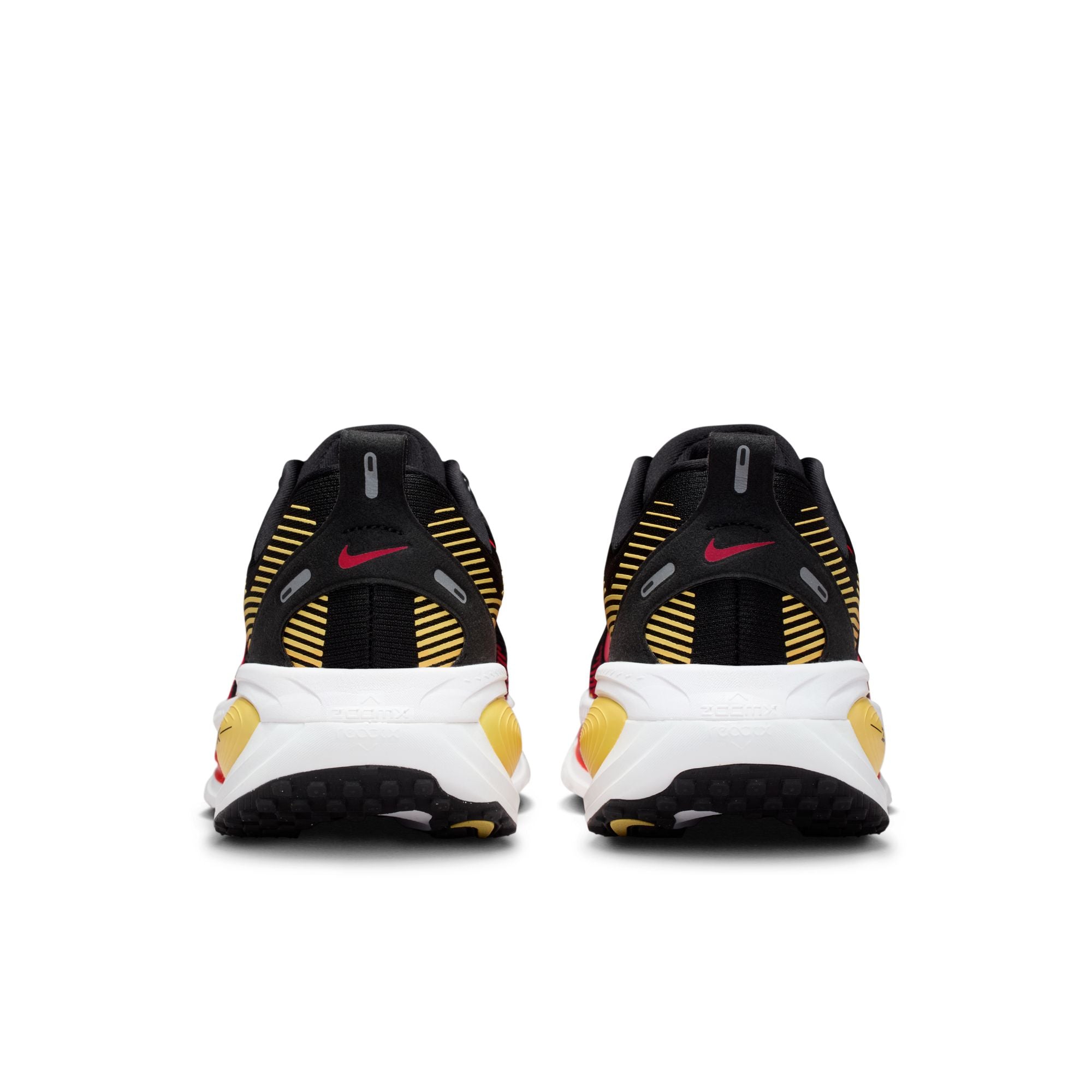 Black, yellow, and white athletic shoes with a visible brand logo on a white background