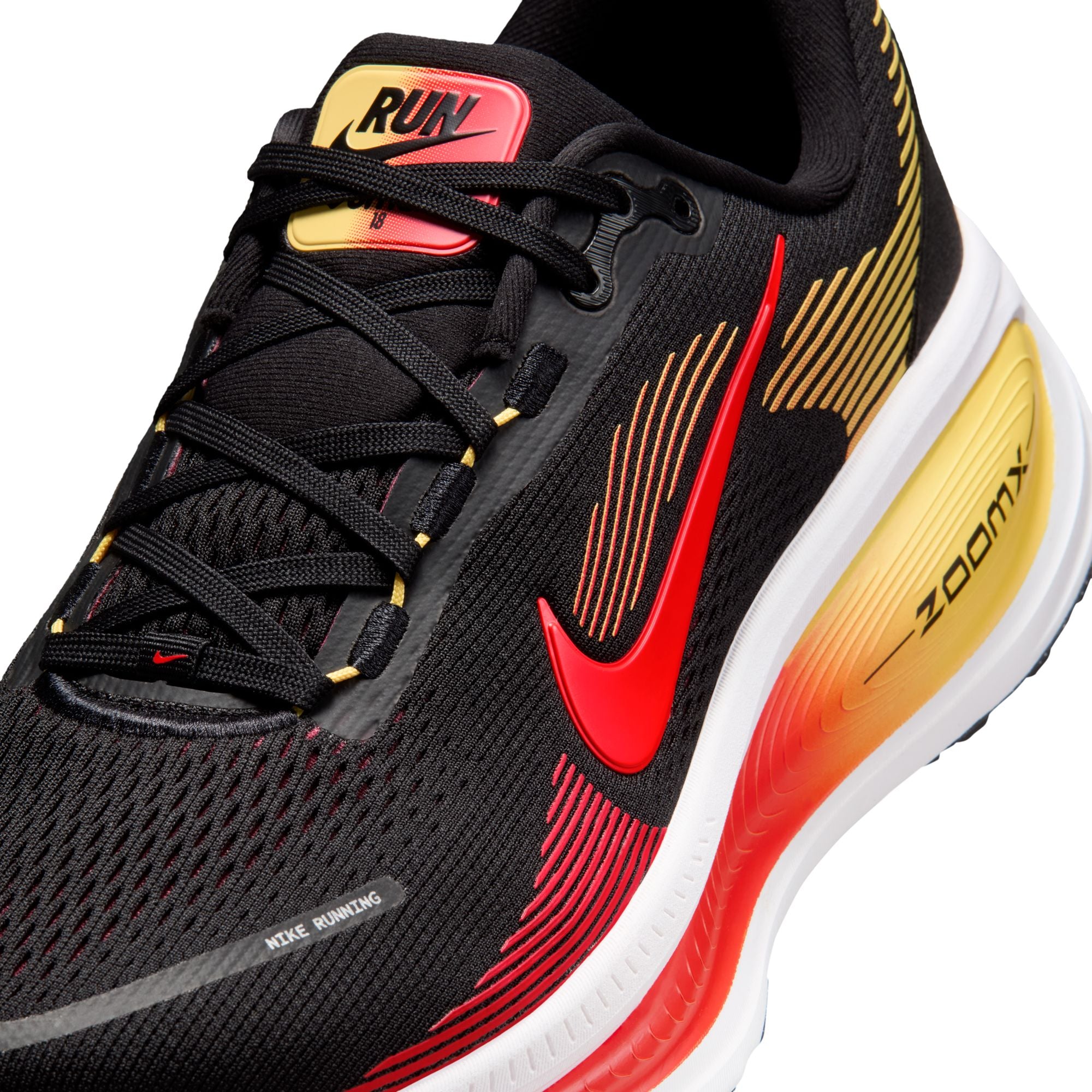 Black running shoe with red and yellow accents on a white background