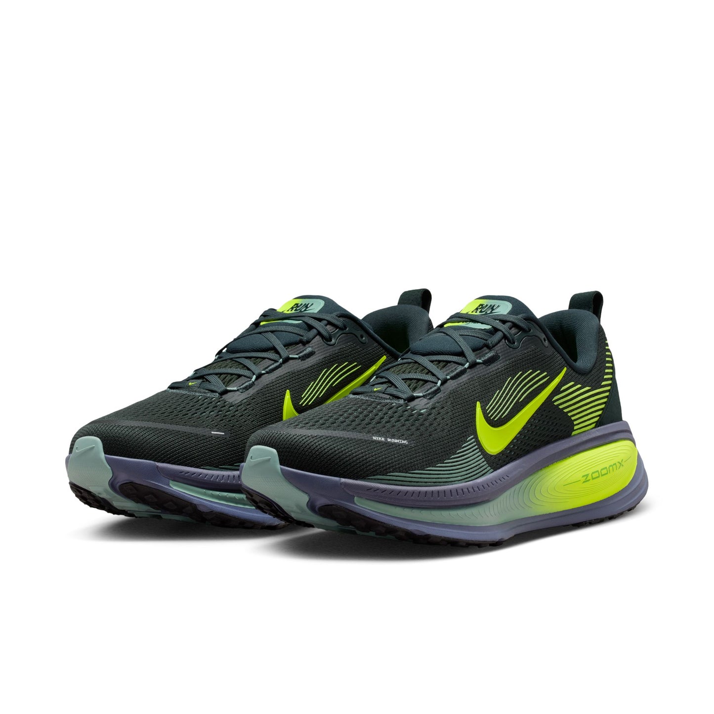 Pair of black and green running shoes on a white background