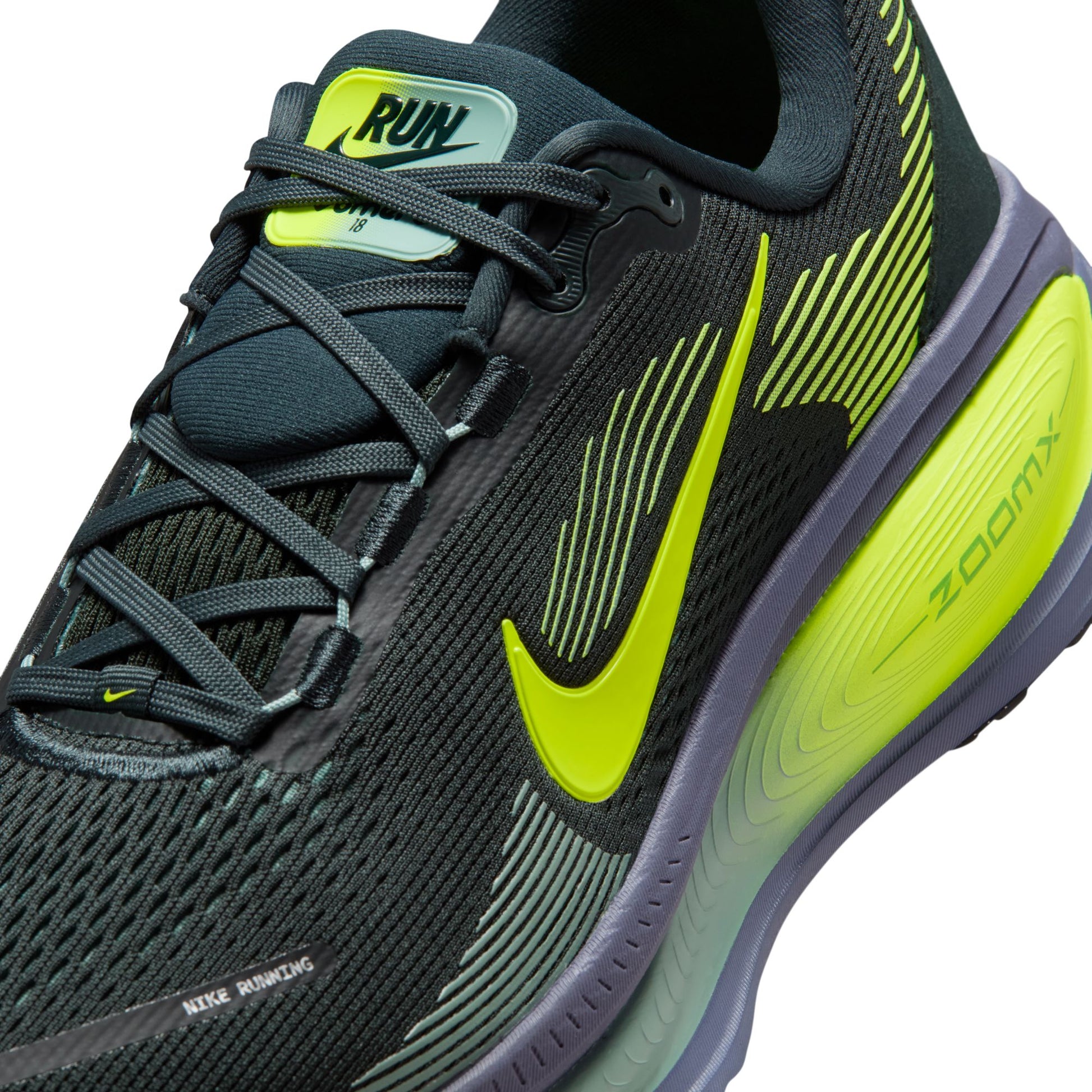 Black and green running shoe with Nike logo on a white background