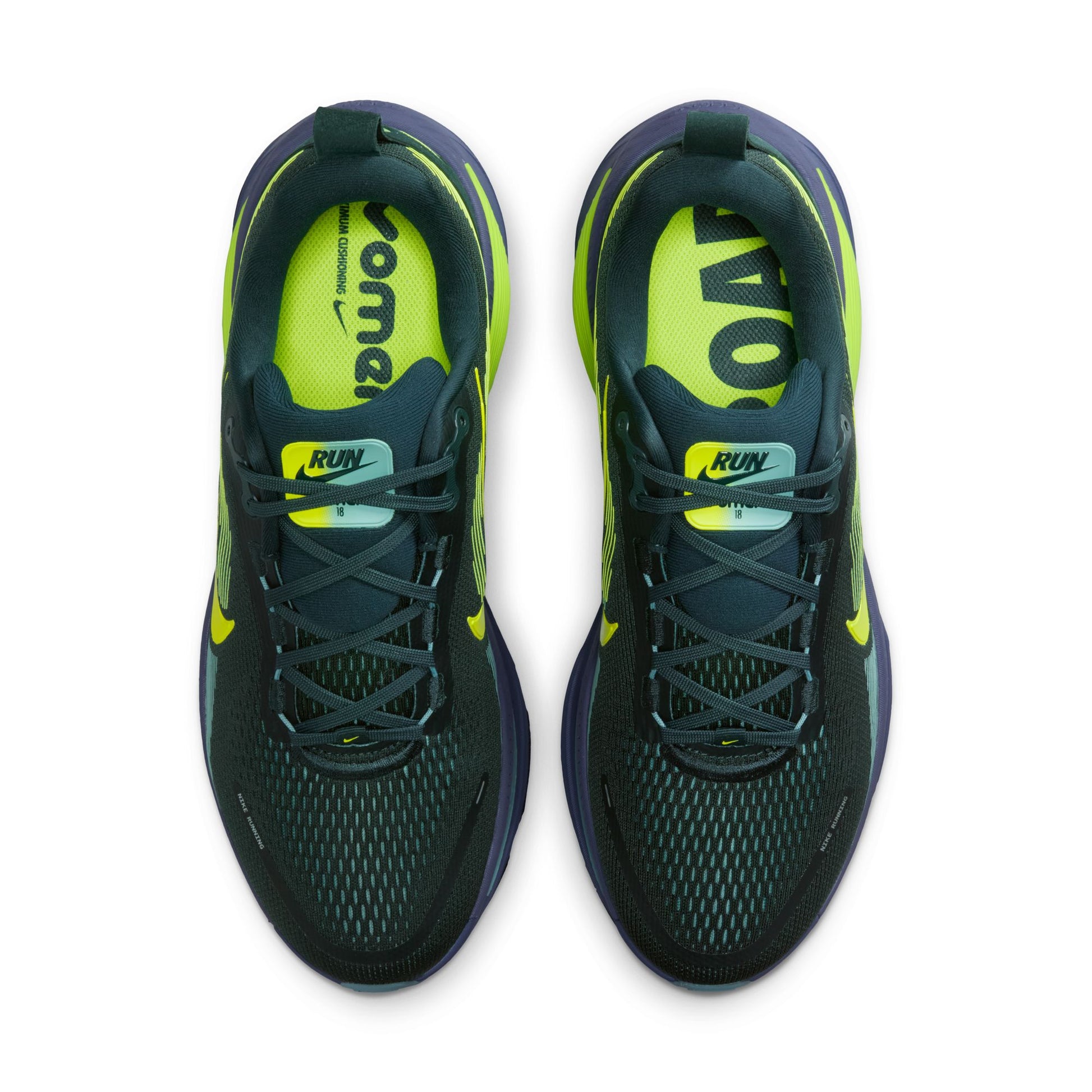 Pair of black and green running shoes on a white background