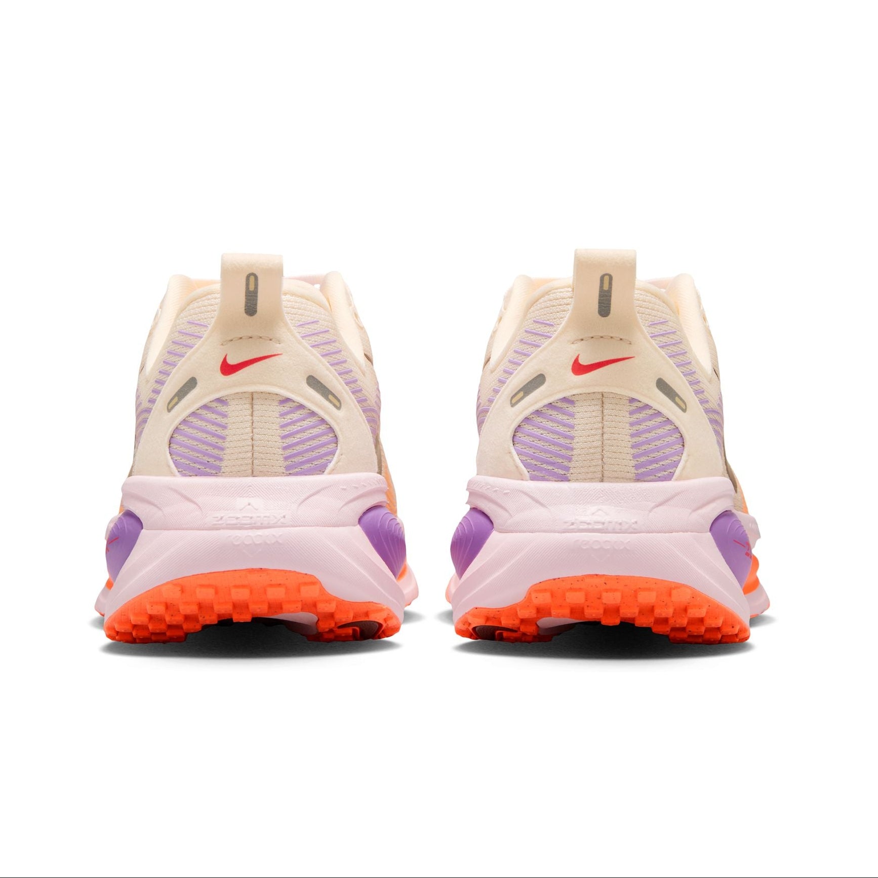 Pair of Nike sneakers with purple and orange accents on a white background